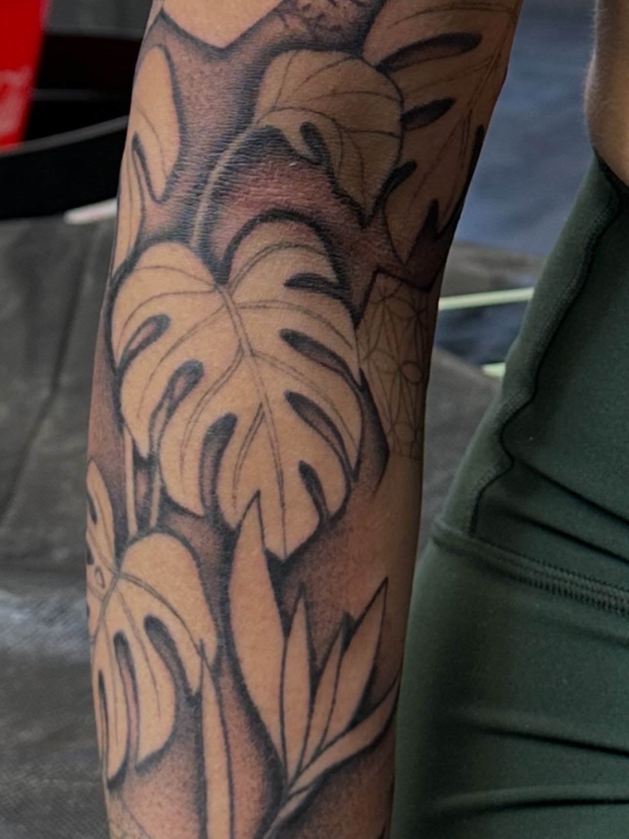 Monstera leaves black and grey tattoo on the forearm by Ciera Farni, Murray, Utah