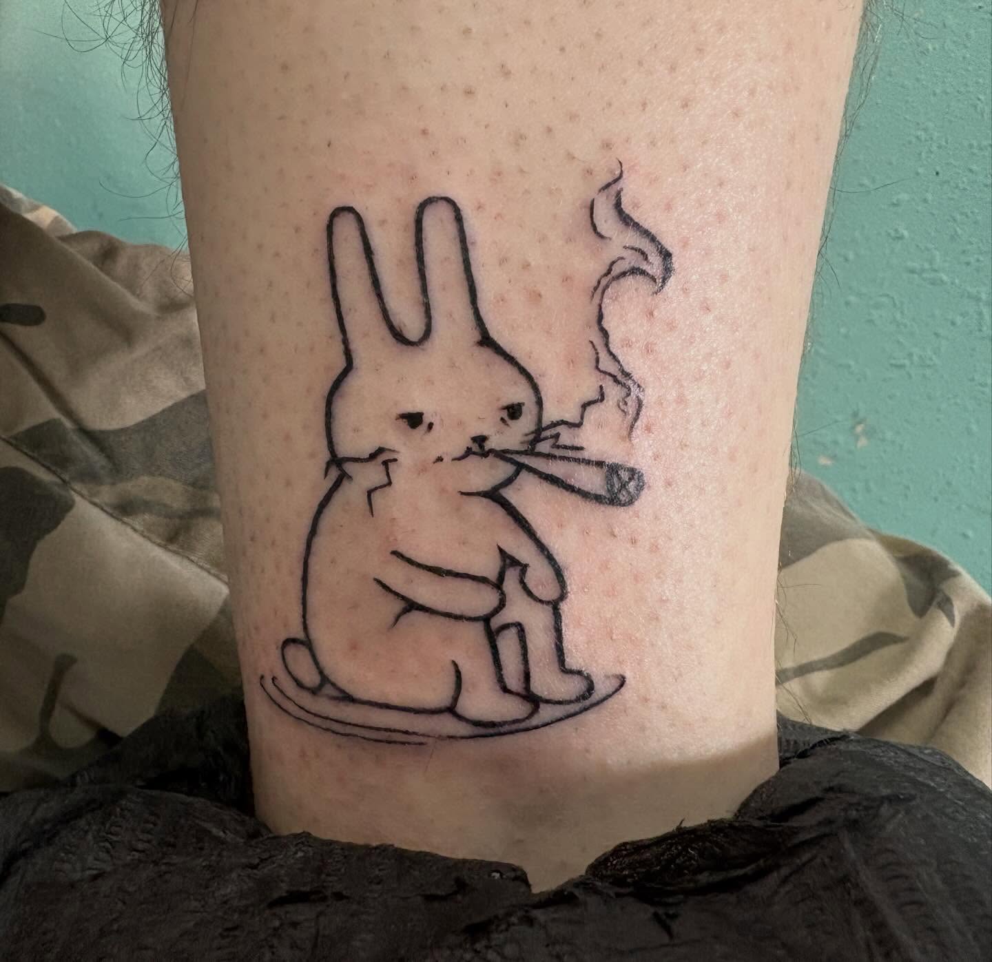 Smoking rabbit black and grey tattoo on the forearm by izzy solae