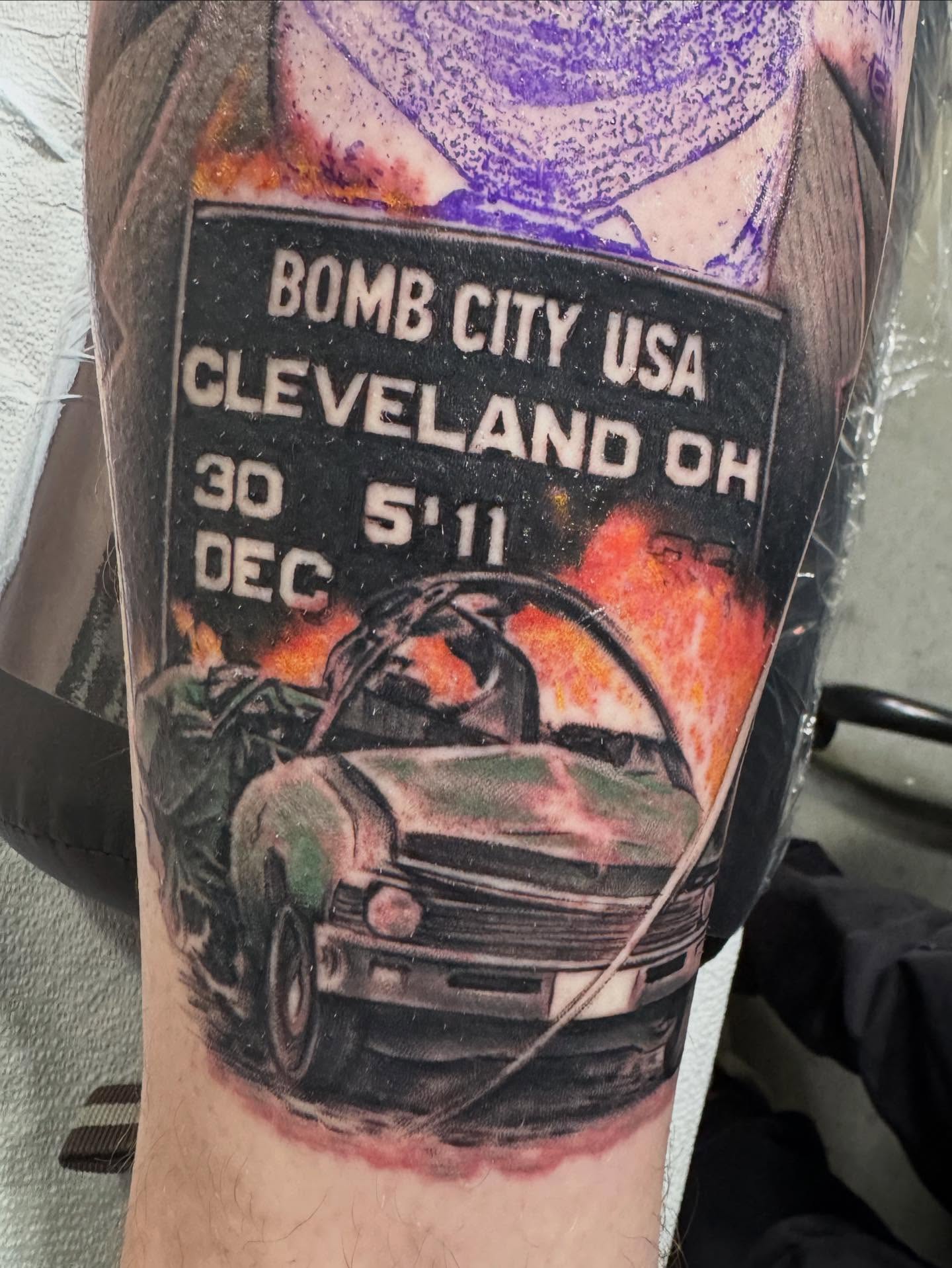 Car explosion realism tattoo on the forearm by Shawn Skale