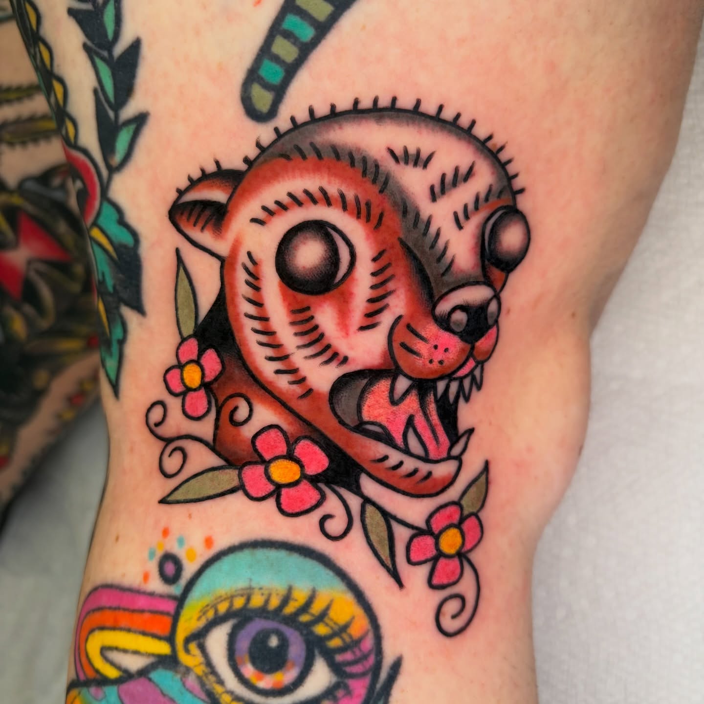 Cat with flowers American traditional tattoo on the forearm by rachael