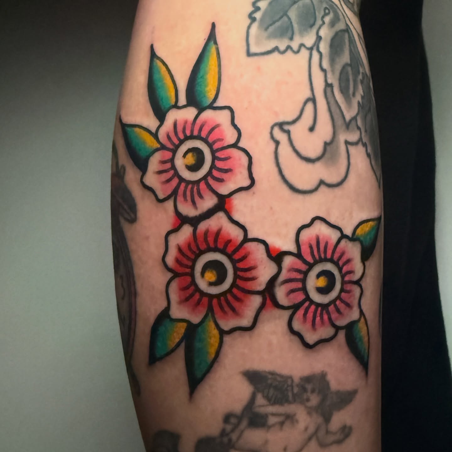 Flowers American traditional tattoo on the forearm by Stevie Lowenstein, Cincinnati, Ohio