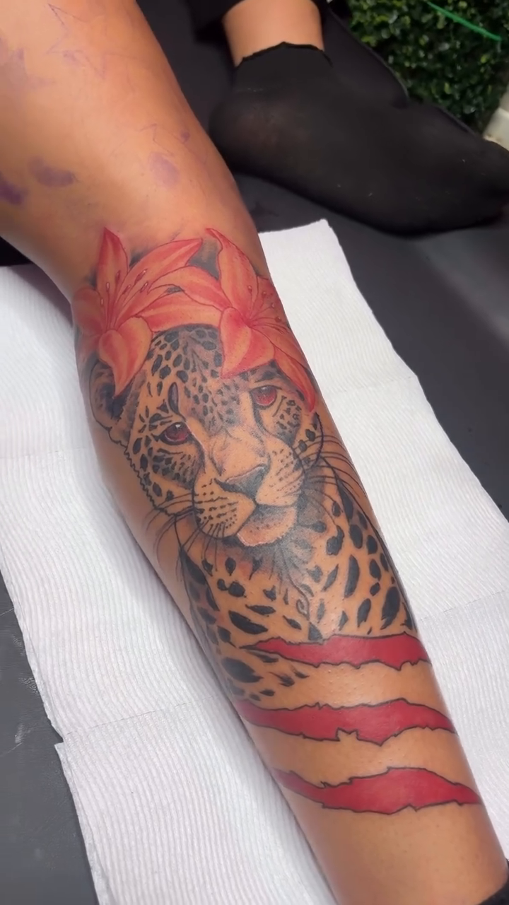 Leopard head with torn skin effect realism tattoo on the forearm by DOE๐๐น