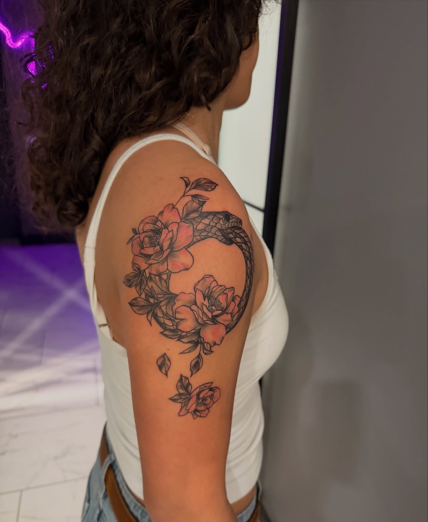 Snake and roses American traditional tattoo on the shoulder by Lexi Odam