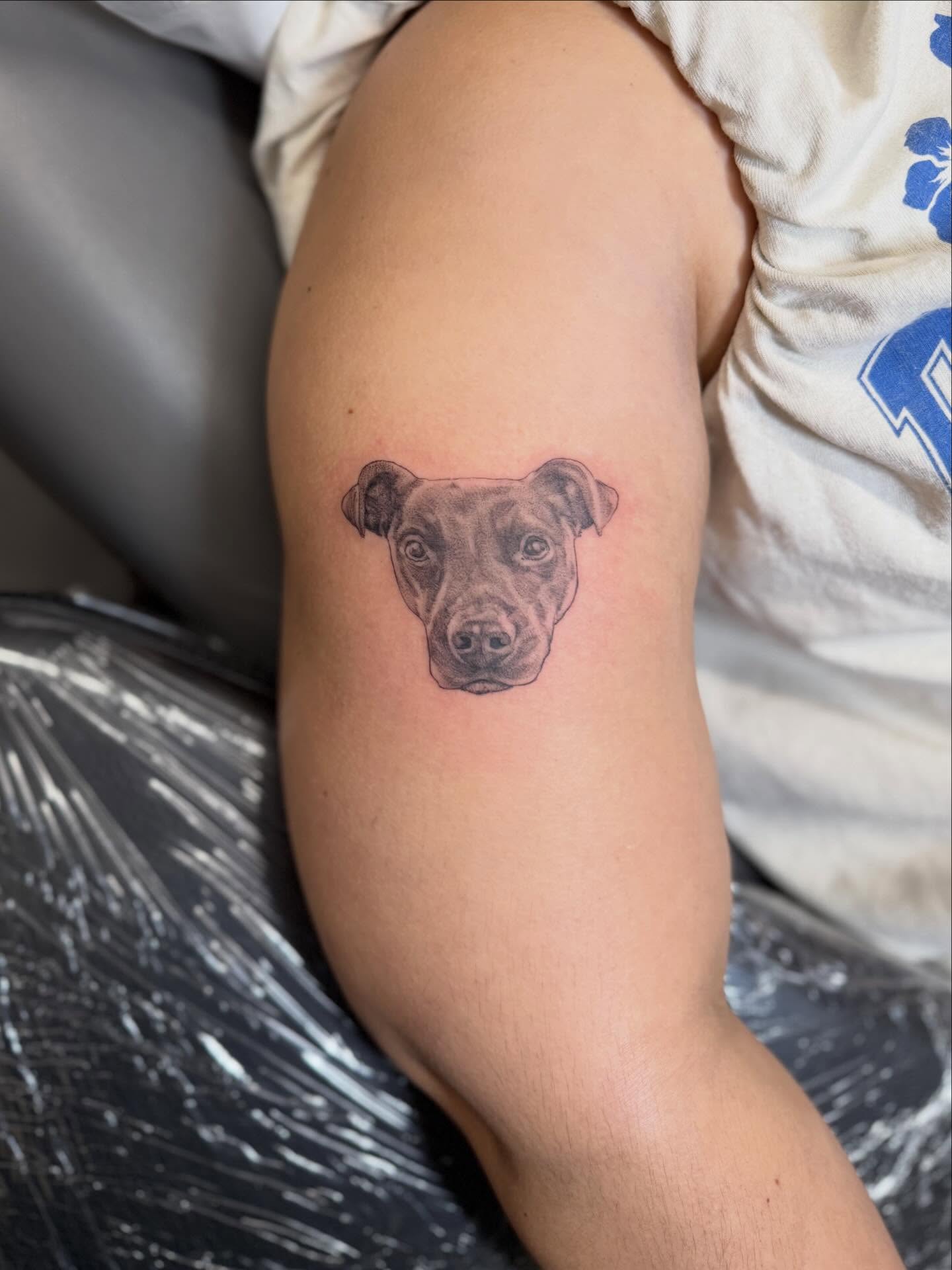 Dog head realism tattoo on the forearm by Peter Harren