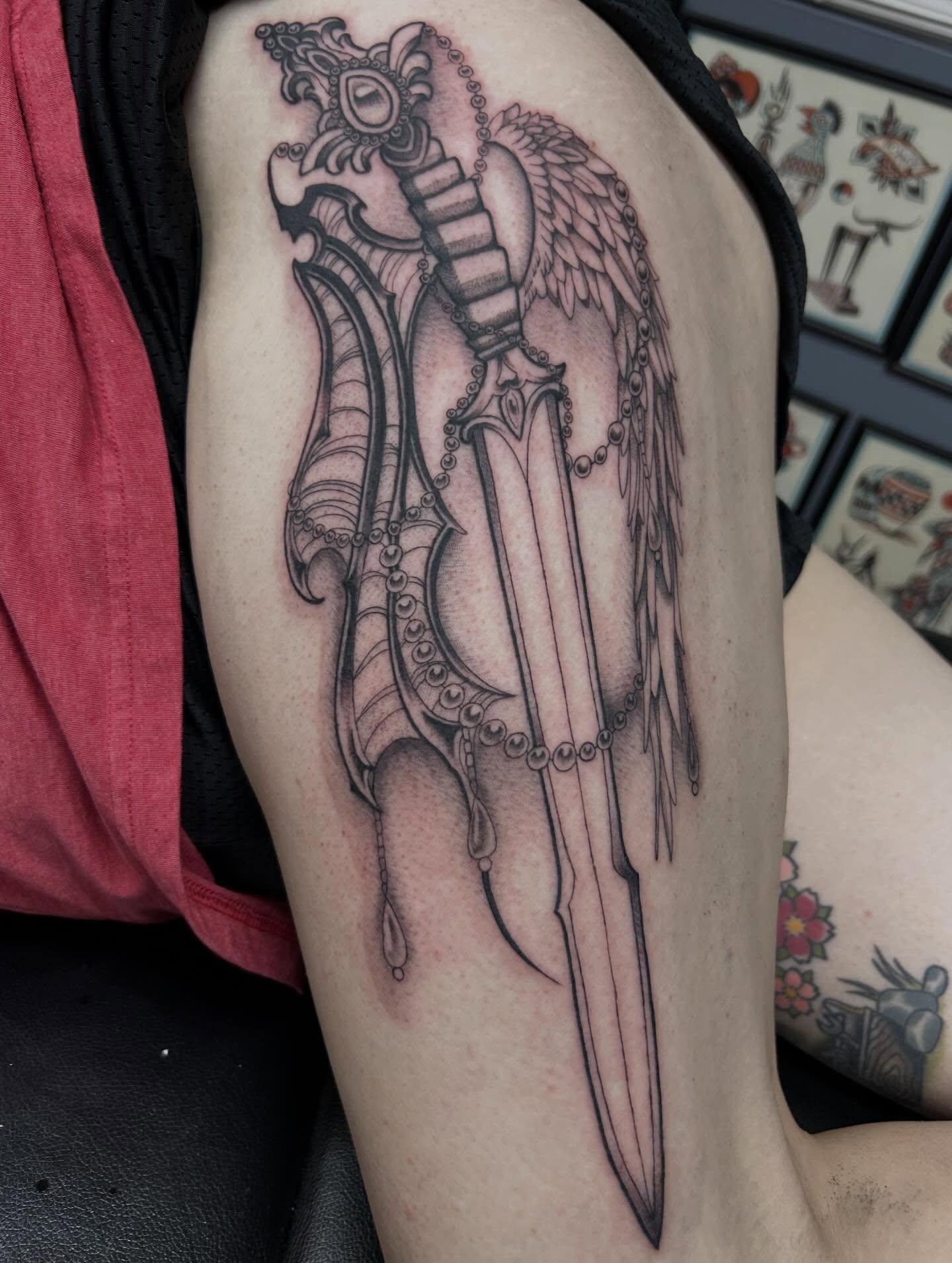 Knife with wings realism tattoo on the forearm by Tiffany Vargas