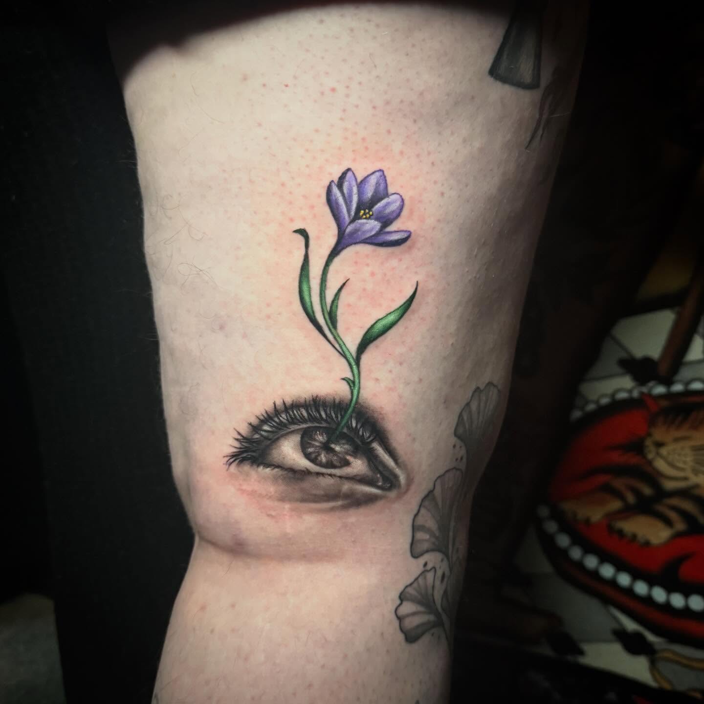 Eye and flower realism tattoo on the forearm by Alexis Monkiewicz