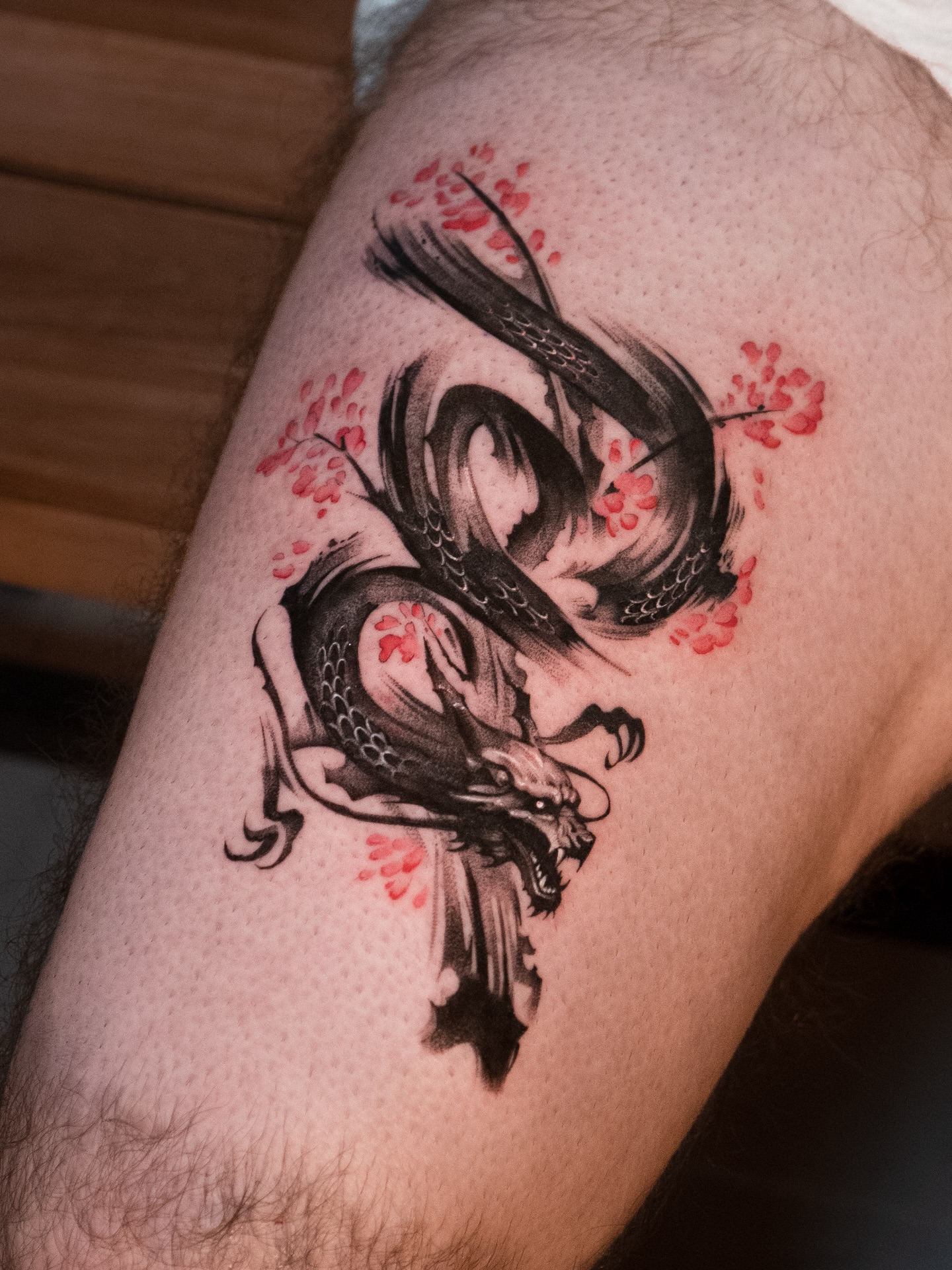 Dragon and cherry blossoms japanese irezumi tattoo on the thigh by Mateo
