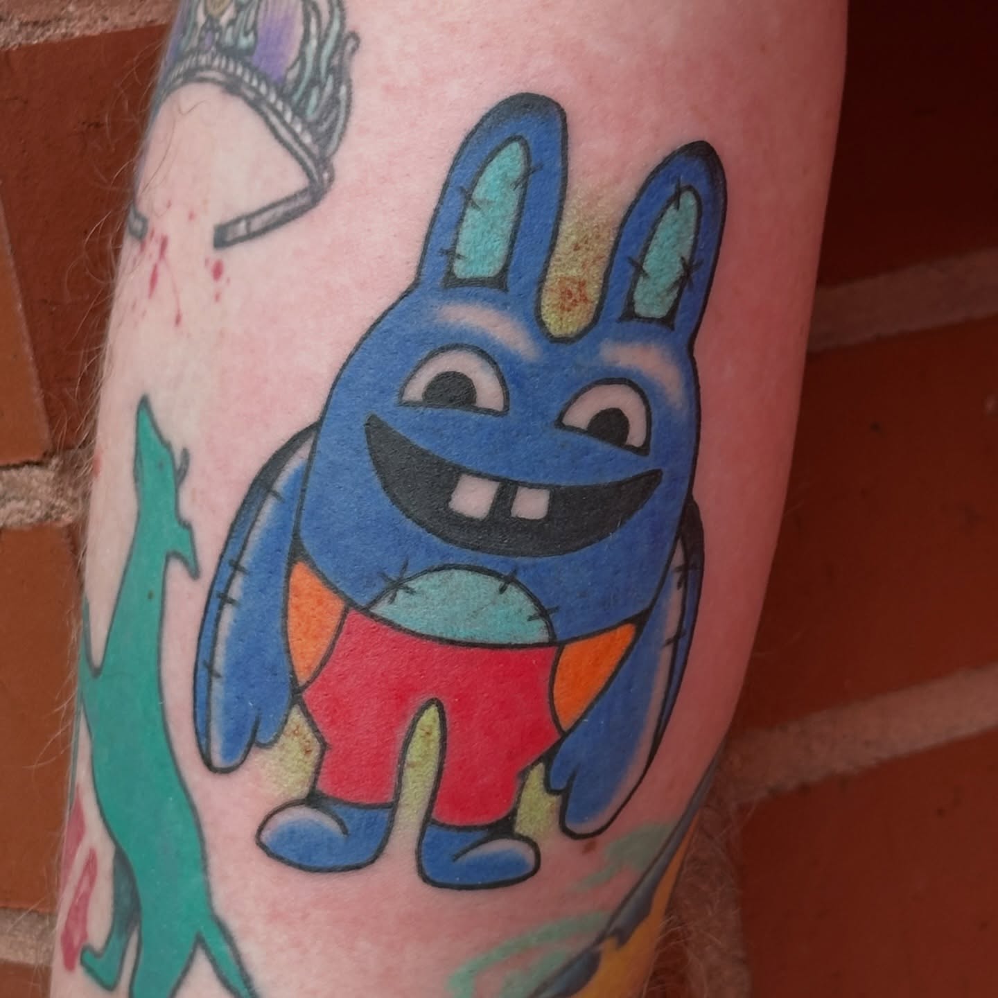 Blue bunny new school tattoo on the forearm by kira