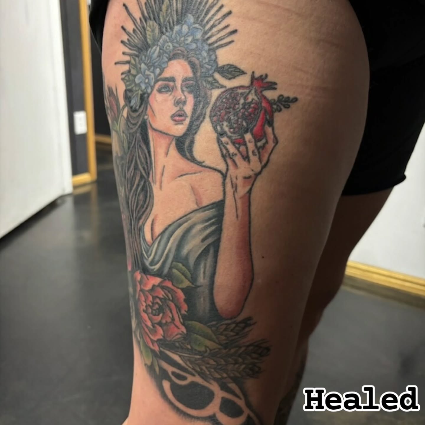 Woman with pomegranate realism tattoo on the thigh by Jentrey McCausland