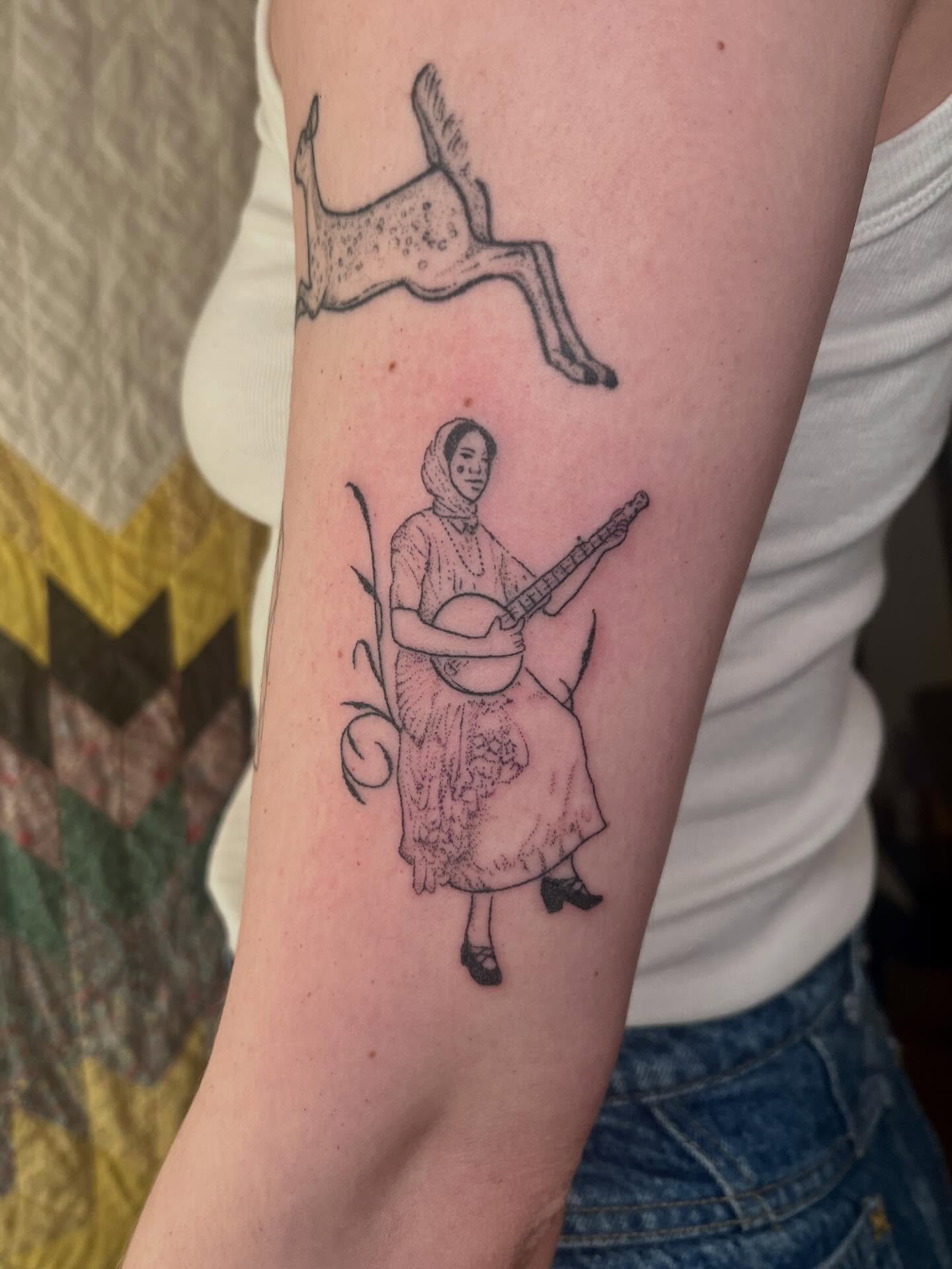 Woman playing banjo dotwork tattoo on the forearm by faith