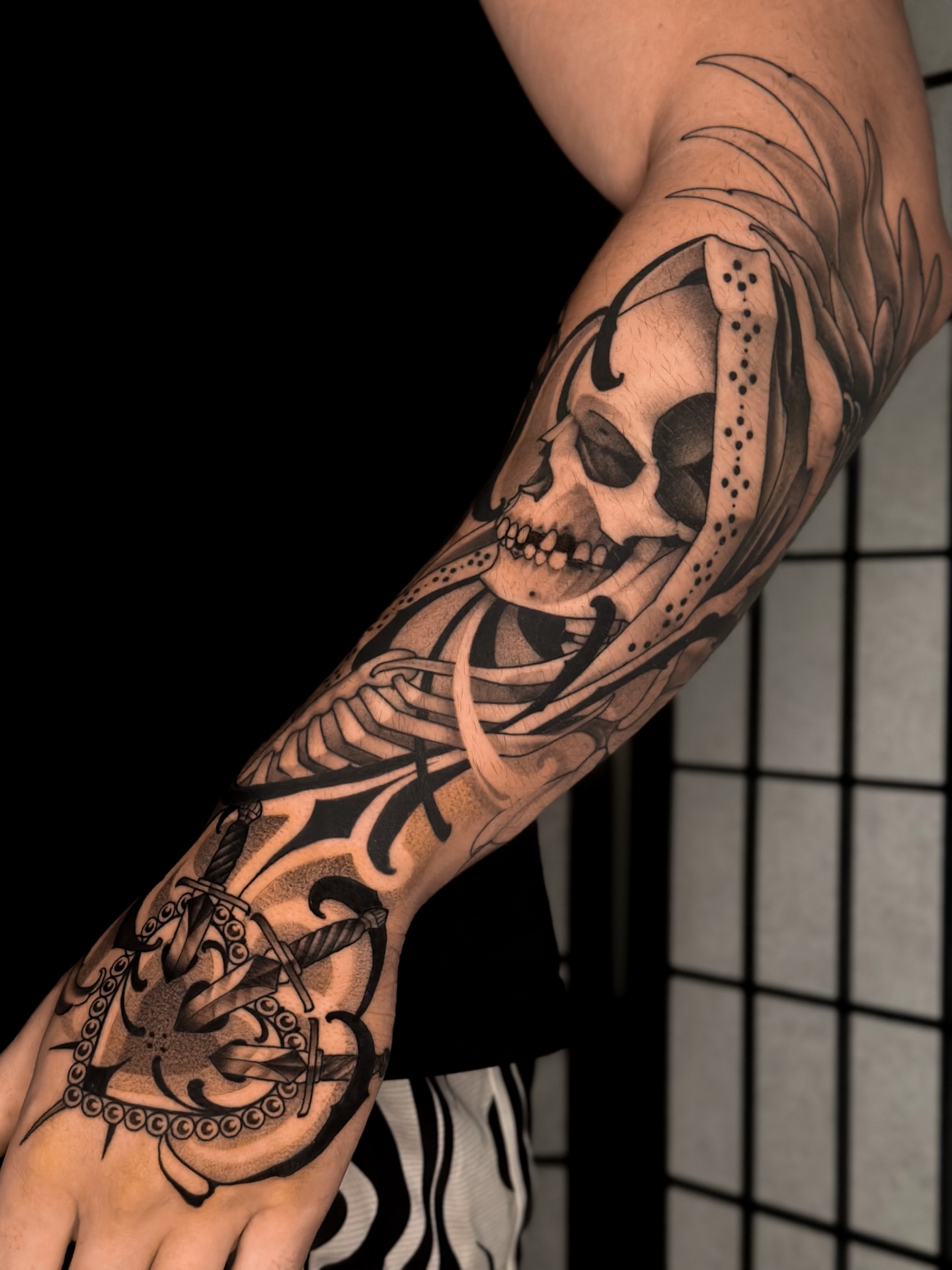 Skull and rope tribal tattoo on the forearm by San Diego