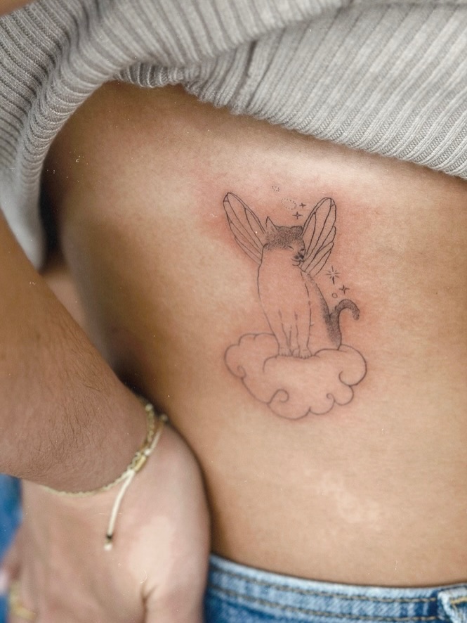 Cat with wings black and grey tattoo on the ribs by 𝗠𝗶𝗱𝗻𝗶𝗴𝗵𝘁 〰️ 𝕄𝕠𝕠𝕟𝕝𝕚𝕘𝕙𝕥