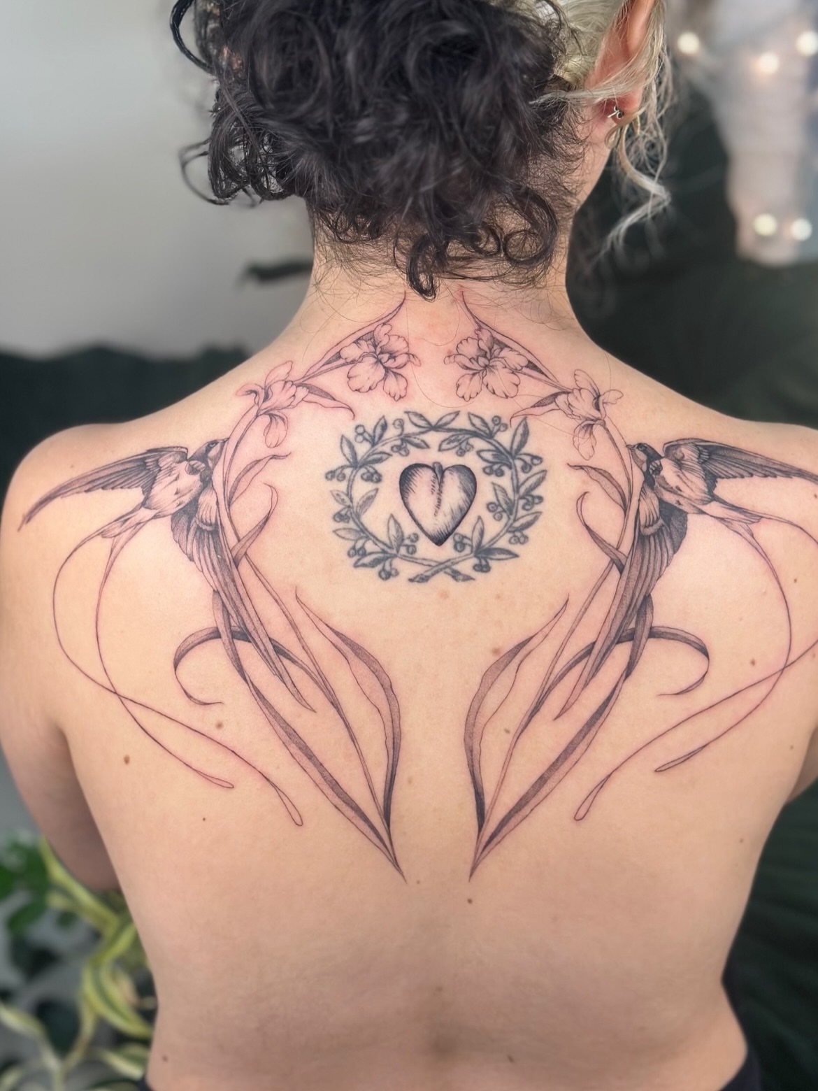 Heart with floral wreath black and grey tattoo on the back by 𝗠𝗶𝗱𝗻𝗶𝗴𝗵𝘁 〰️ 𝕄𝕠𝕠𝕟𝕝𝕚𝕘𝕙𝕥
