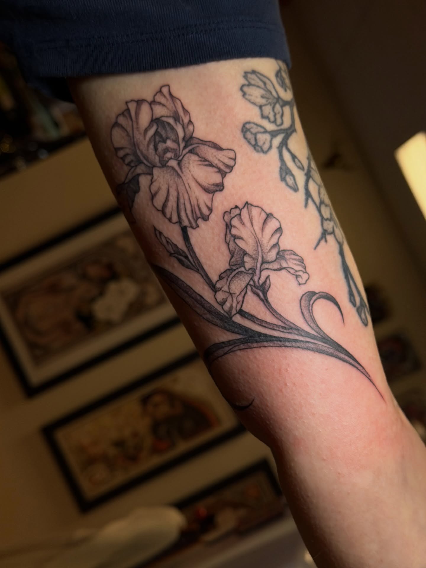 Iris flowers black and grey tattoo on the forearm by Gianna Calisi