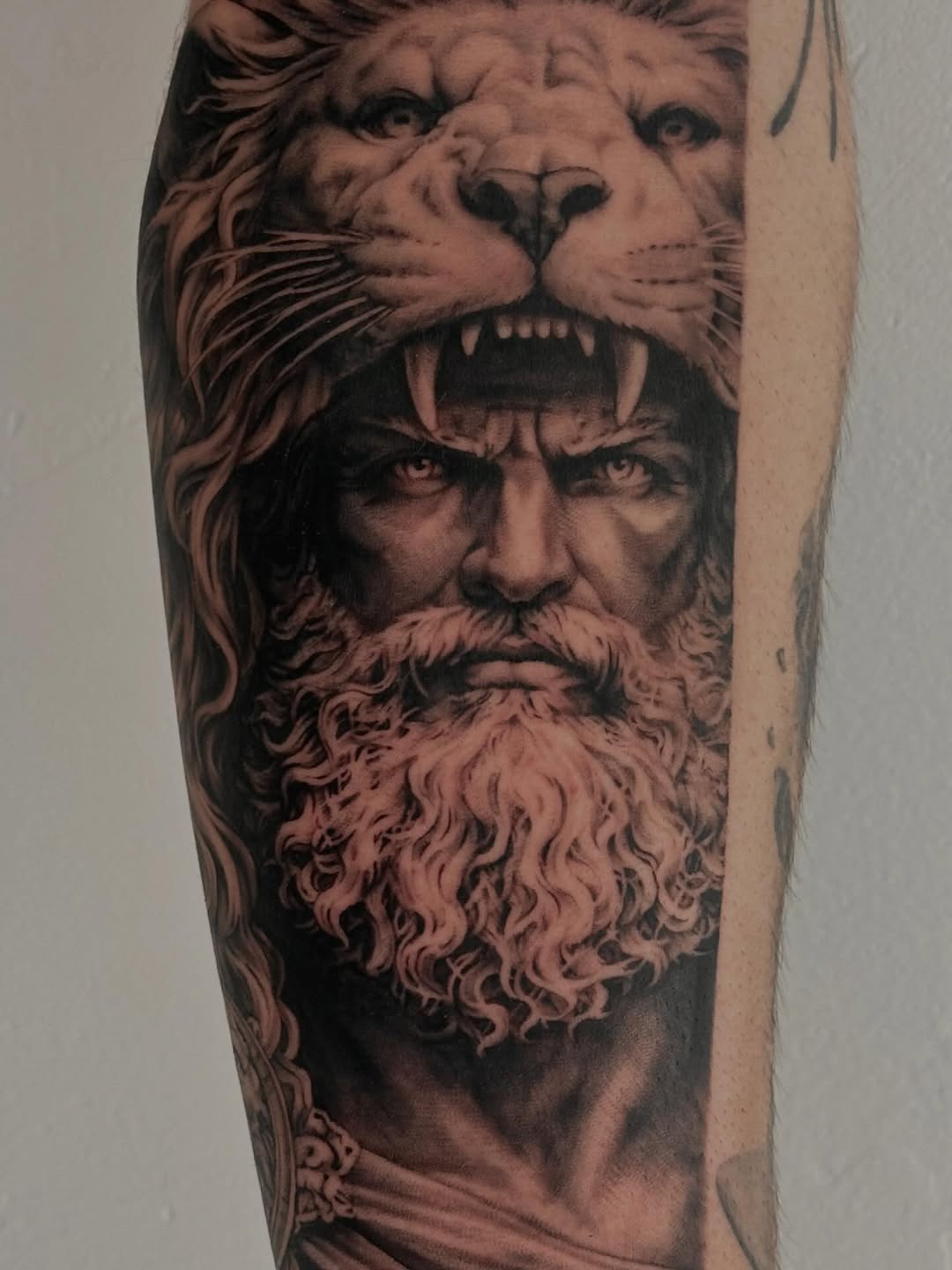Man wearing lion headdress surrealism tattoo on the forearm by Winters Ashurst - St. George tattoo artist