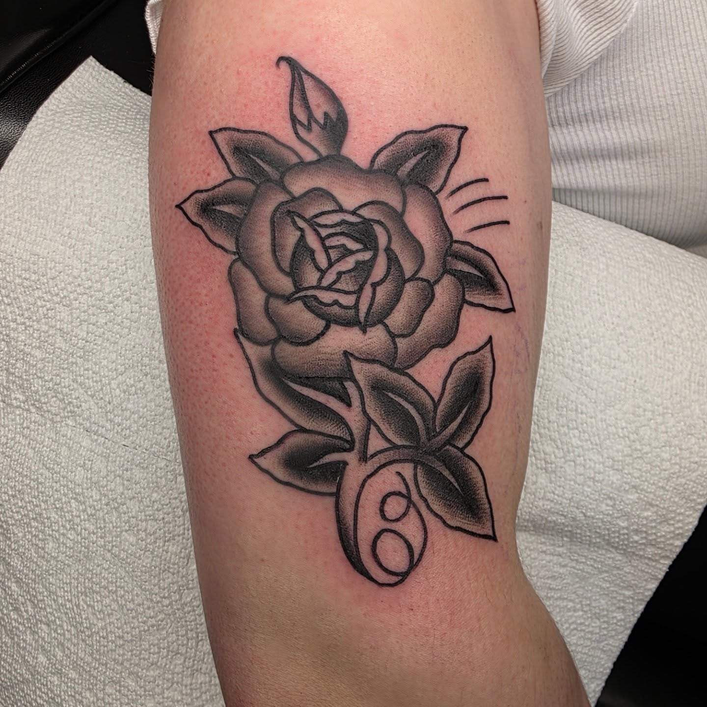 Rose black and grey tattoo on the forearm by Adam Garnek