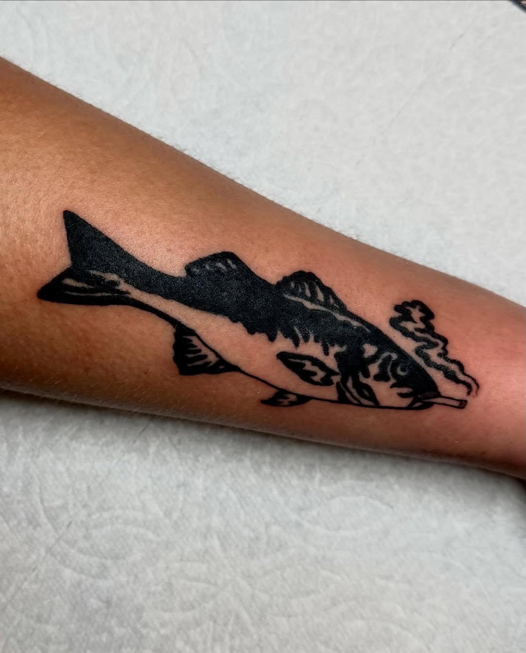Smoking fish fine line tattoo on the forearm by savannah