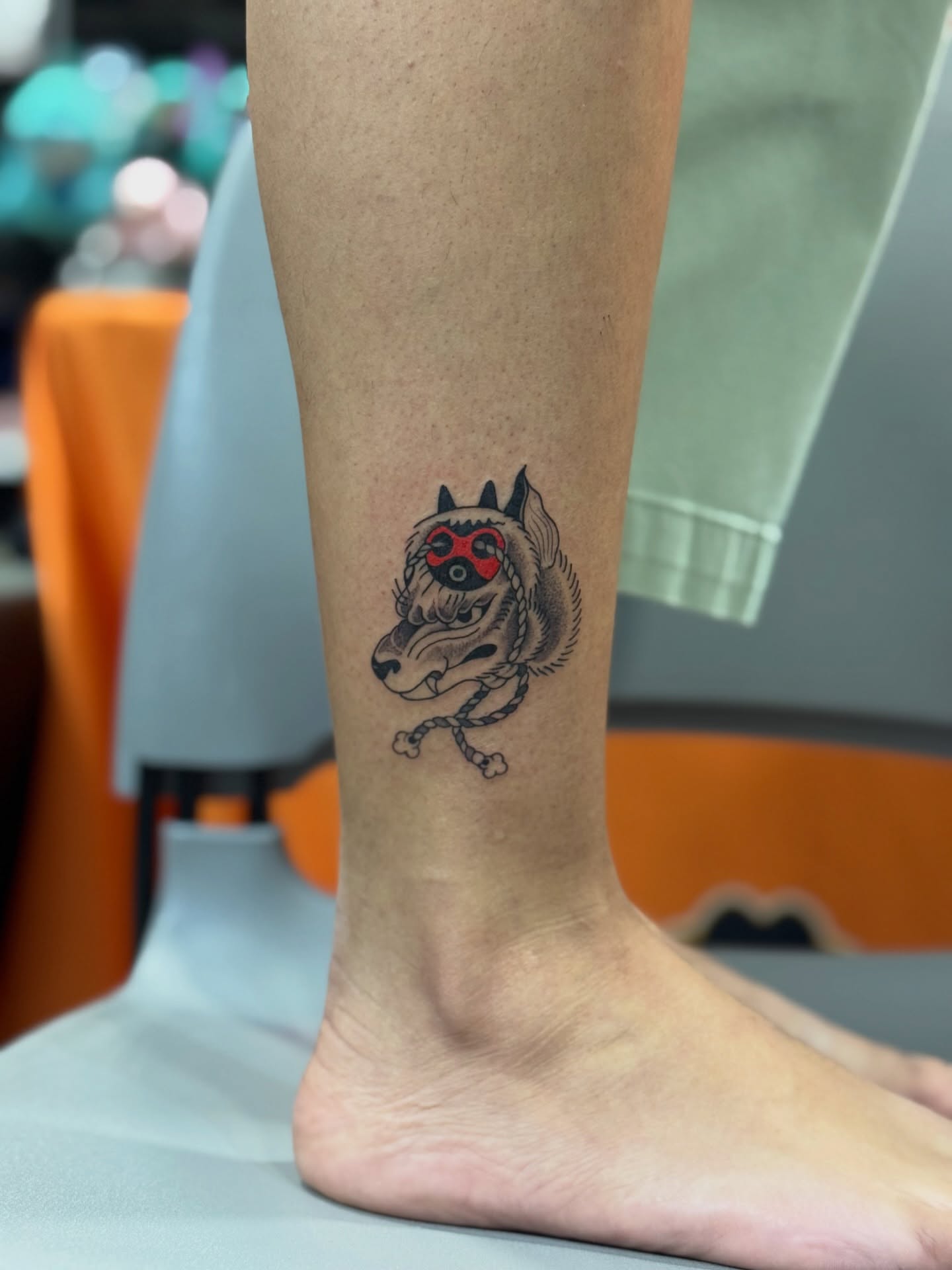 Wolf mask black and grey tattoo on the calf by North County Sd