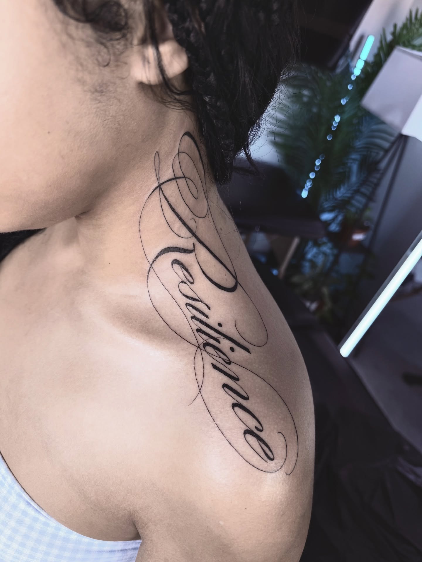 Resilience lettering script tattoo on the shoulder by Jevon Glasco Tattoos