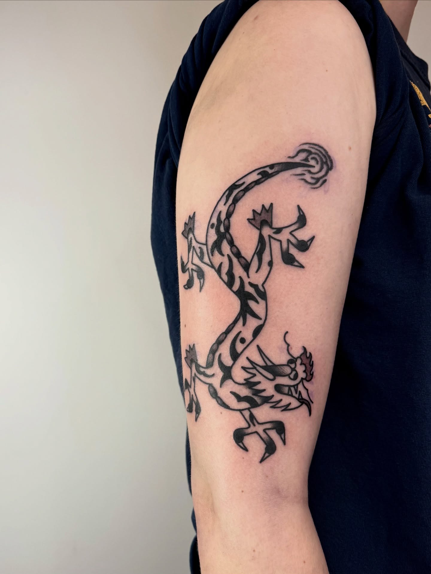 Lizard black and grey tattoo on the forearm by Roman