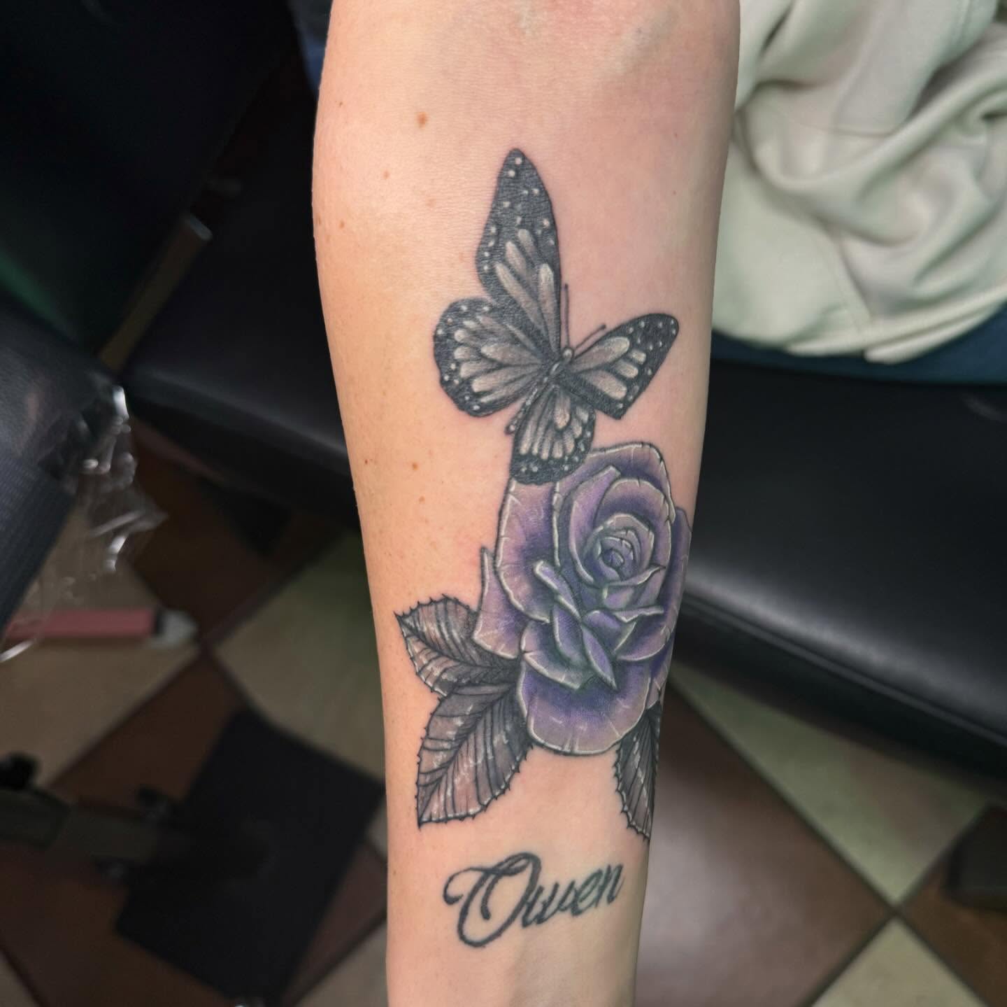 Rose and butterfly realism tattoo on the forearm by Nina Rush