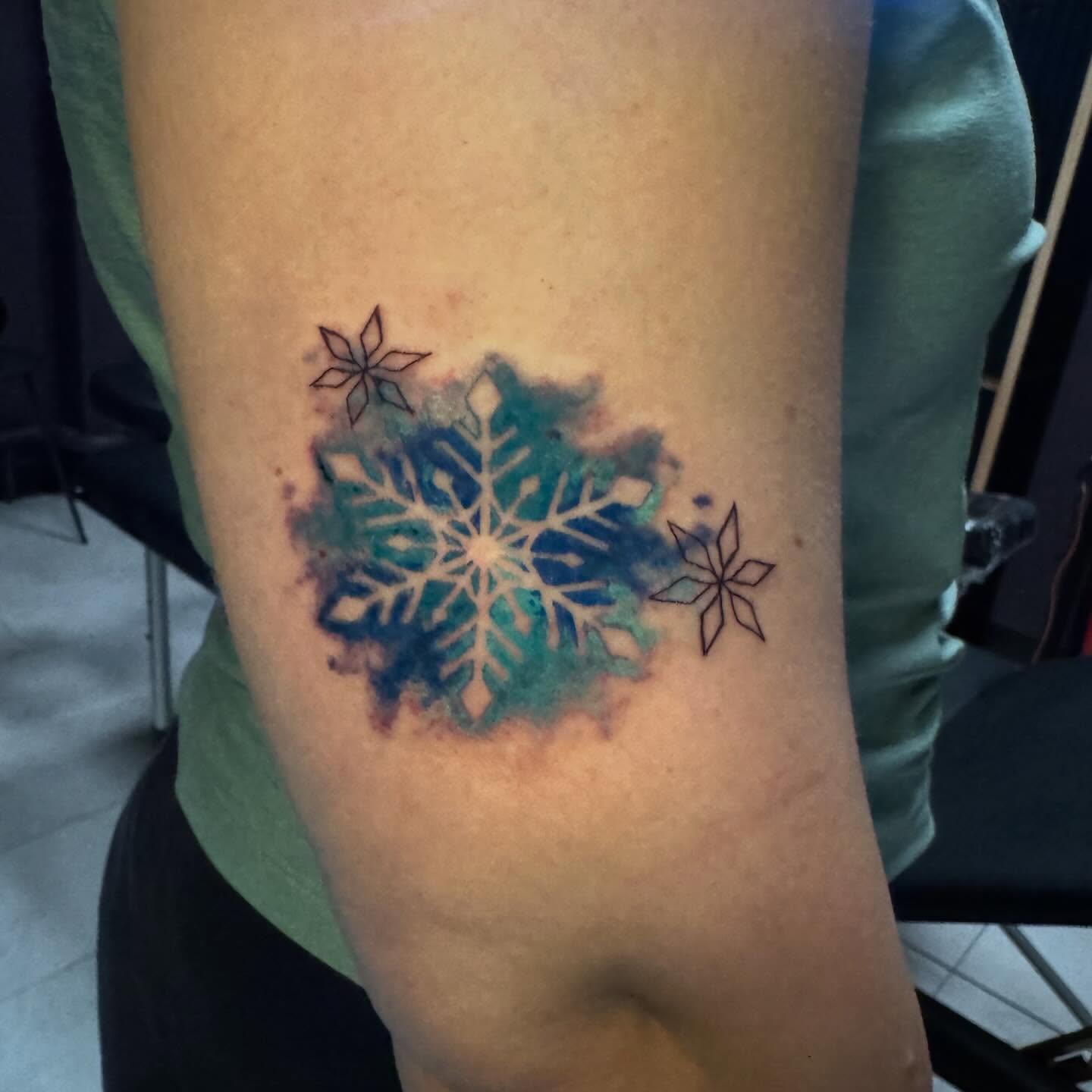 Snowflake watercolor tattoo on the forearm by Lindsay