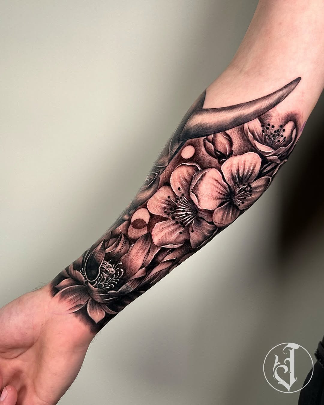 Lotus and cherry blossoms with horn Japanese tattoo on the forearm by Tattoos By Josh