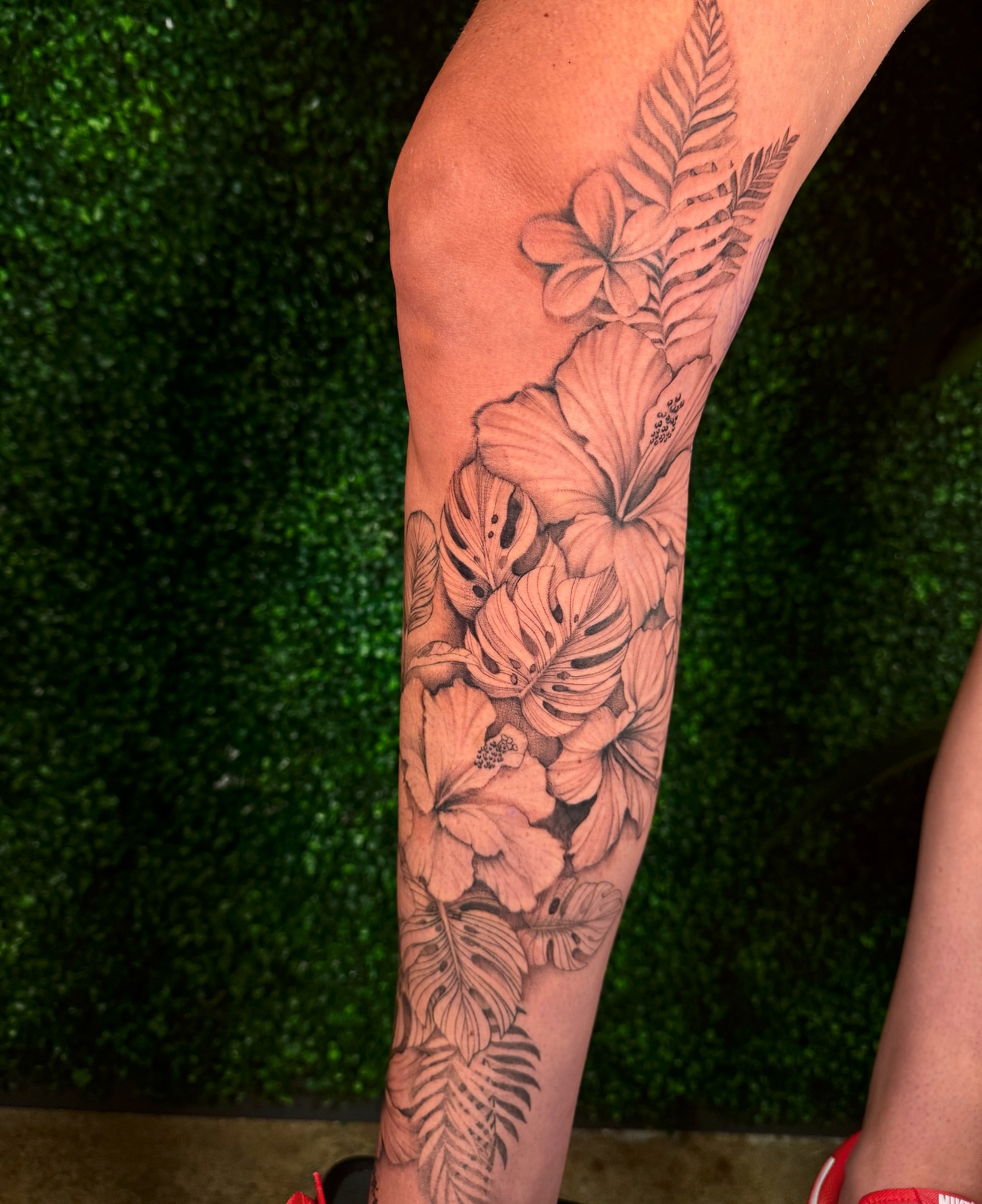 Hawaiian flowers black and grey tattoo on the forearm by Cyn