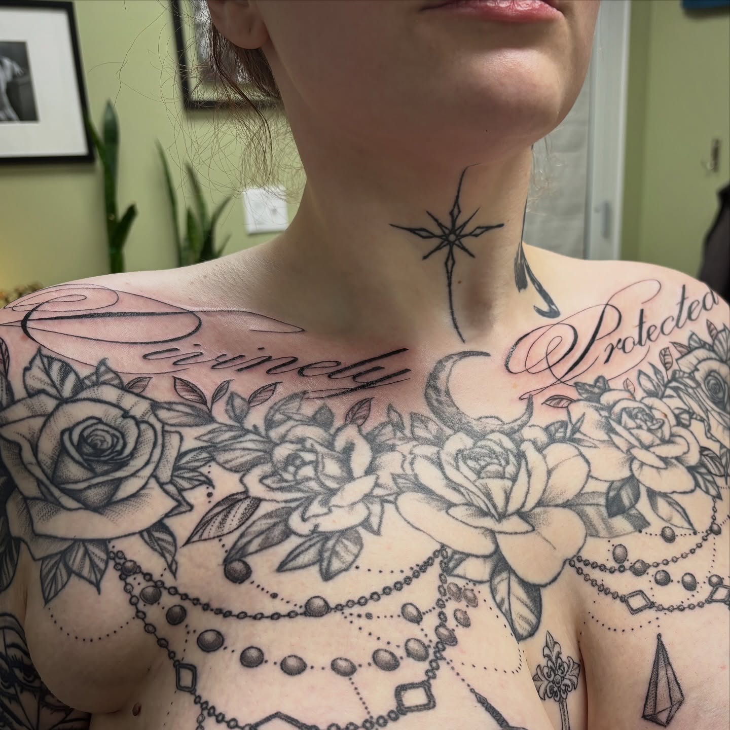 Floral and geometric dotwork tattoo on the chest by sydney honn