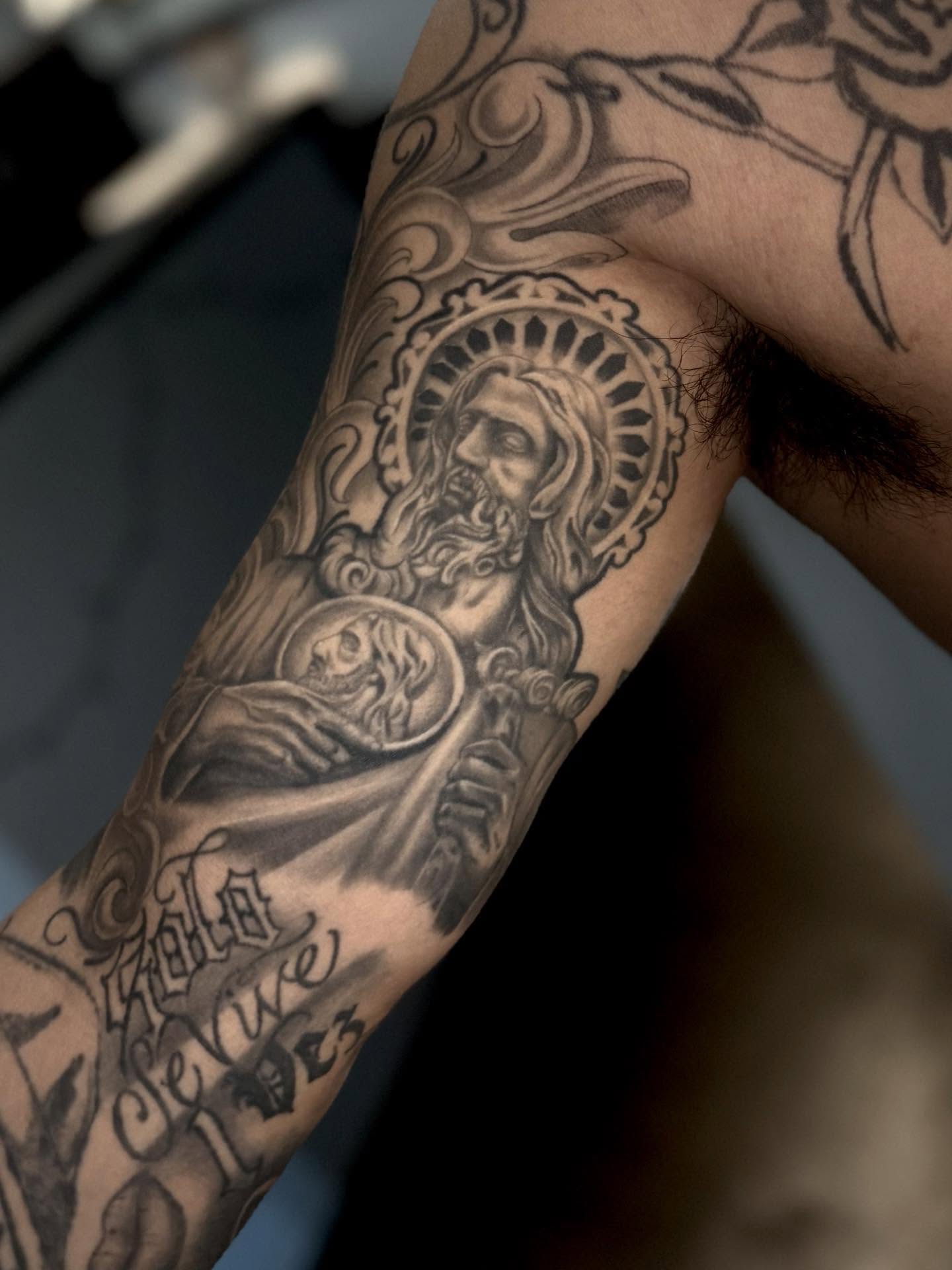 Religious figure with skull black and grey tattoo on the forearm by Stilow Memphis Tattoo Artist, Memphis, Tennessee
