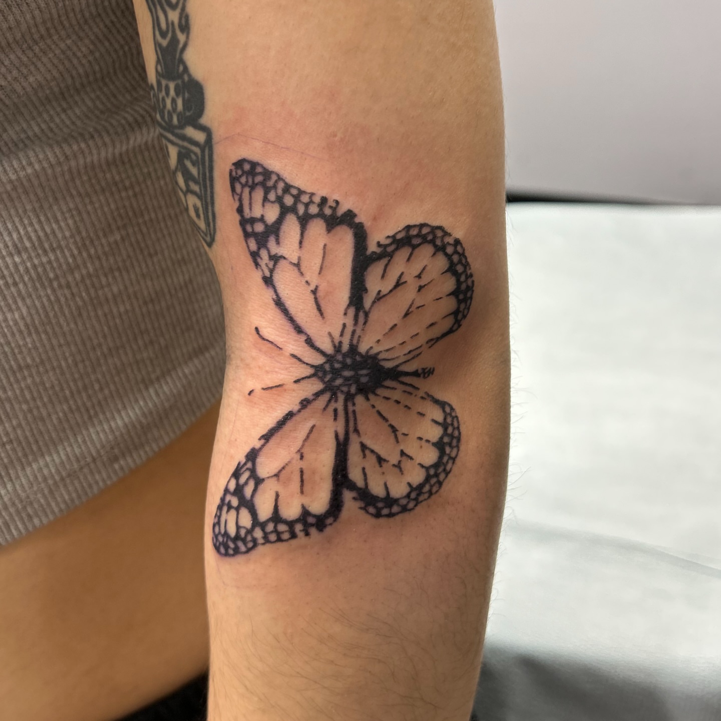 Butterfly black and grey tattoo on the forearm by Natalie Johnson, Minneapolis, Minnesota