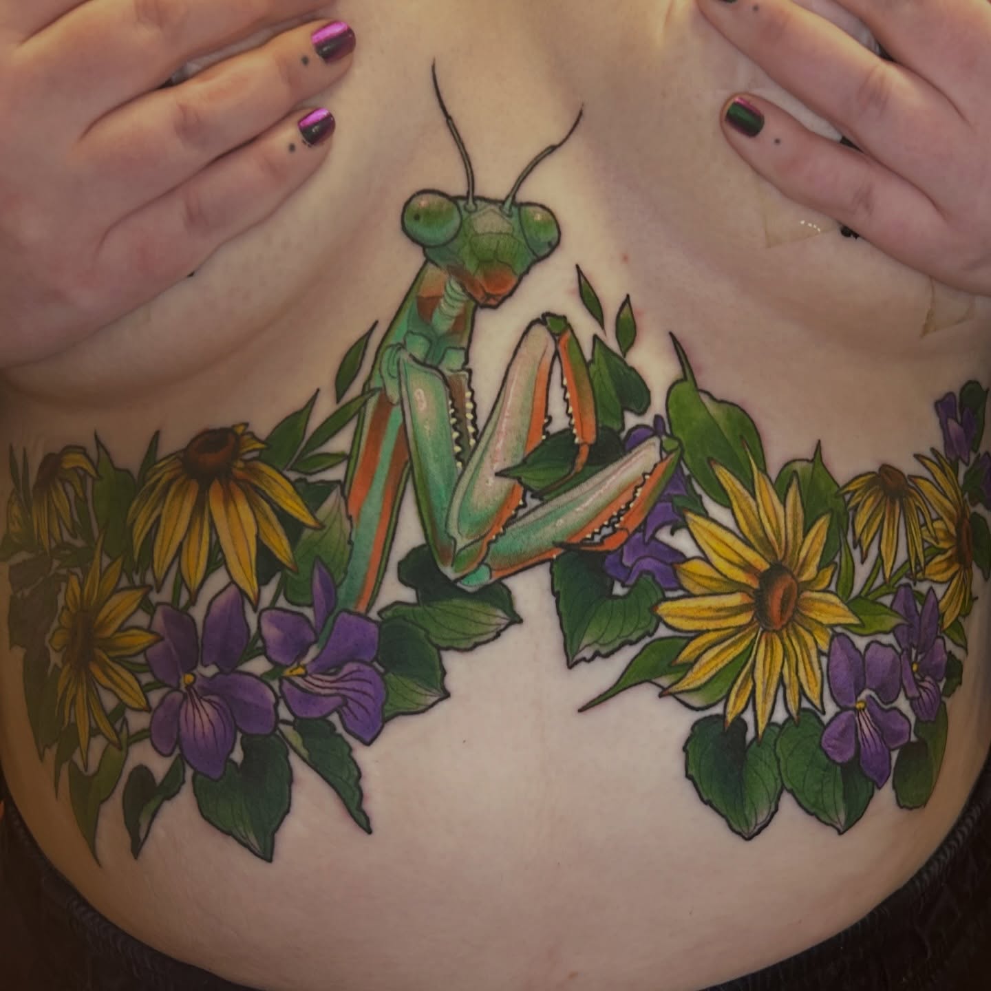 Praying mantis and flowers realism tattoo on the chest by Anna Sylvan Tattoos