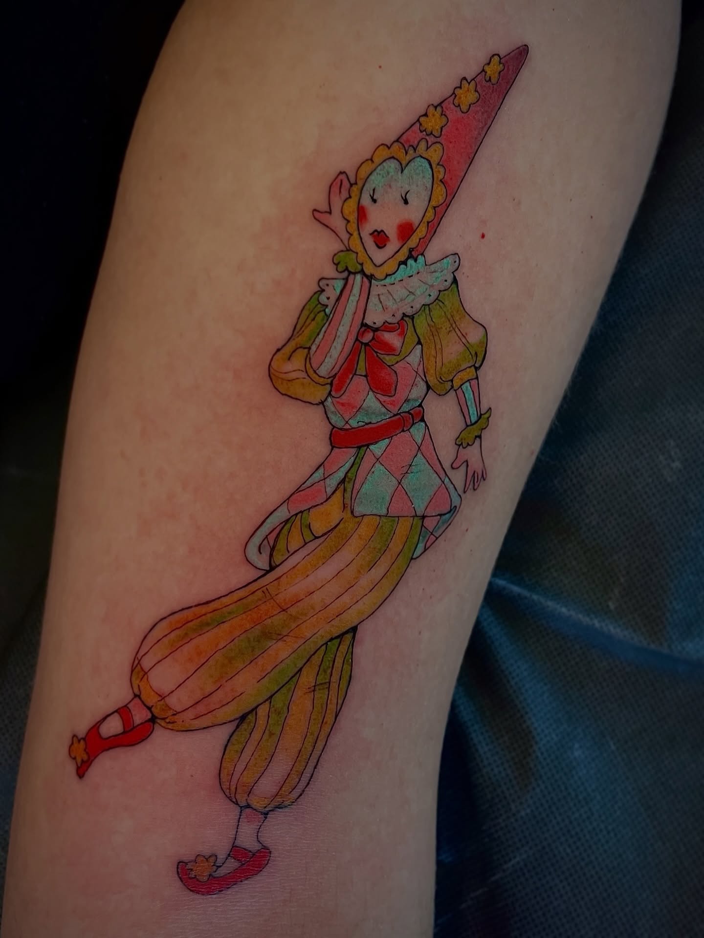 Clown illustrative tattoo on the thigh by Andrea Patterson