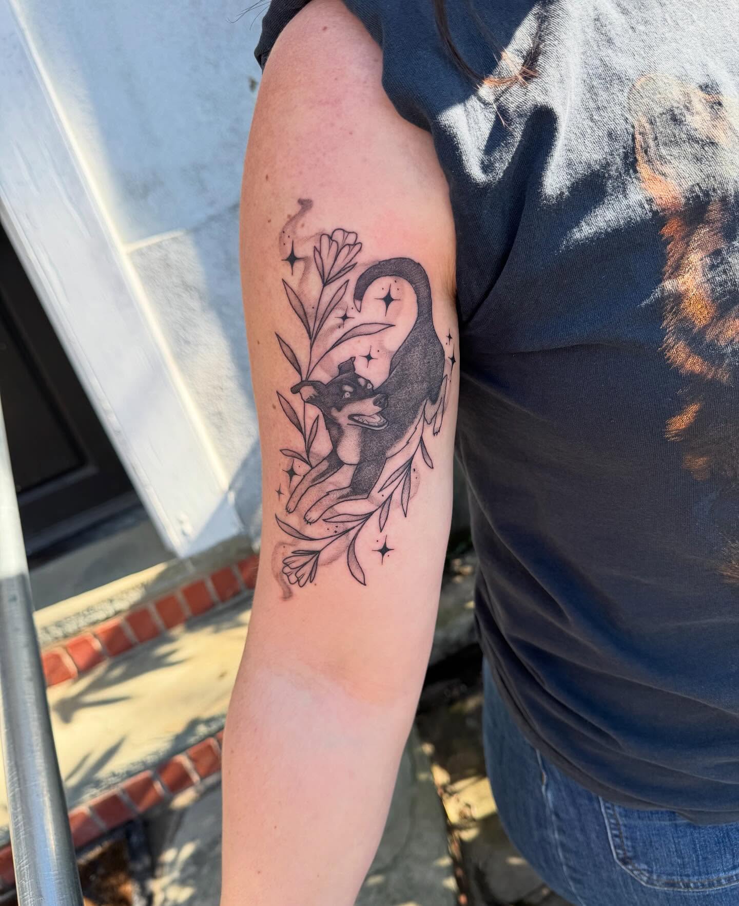 Cat and floral black and grey tattoo on the forearm by Tattoos by Alex