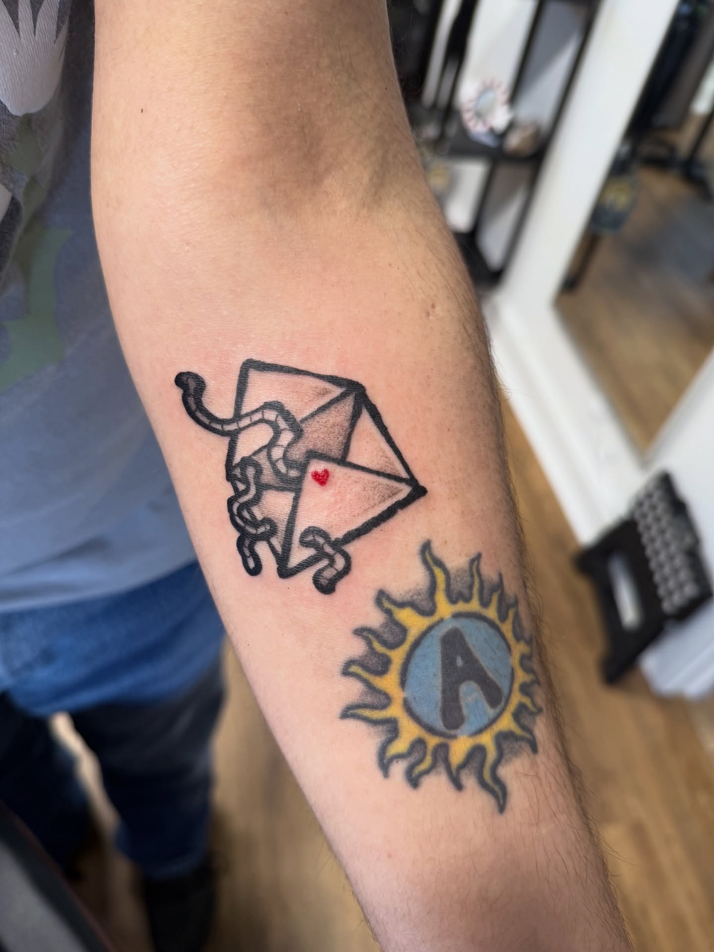 Envelope with snake American traditional tattoo on the forearm by z o y a, Seattle, Washington