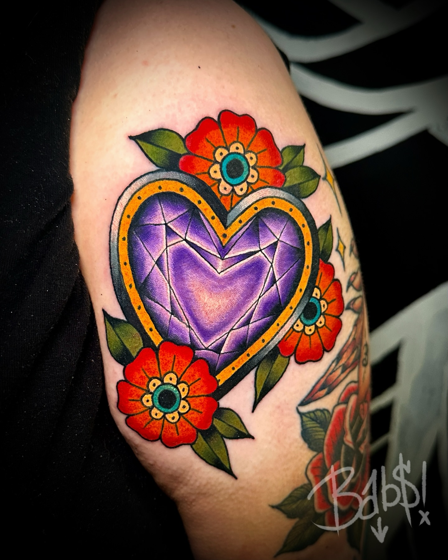 Heart with flowers American traditional tattoo on the shoulder by Justin B