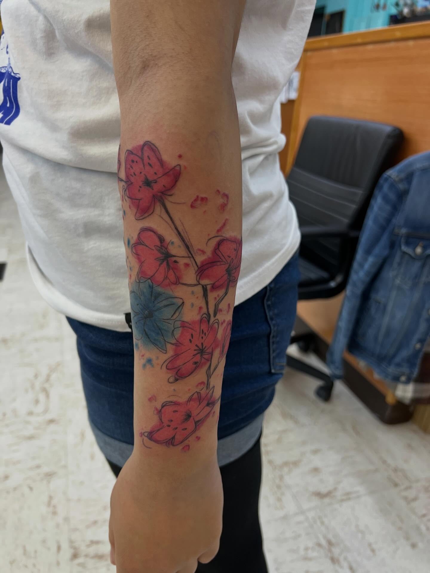 Watercolor flowers watercolor tattoo on the forearm by Levi Sawdon, Everett, Washington