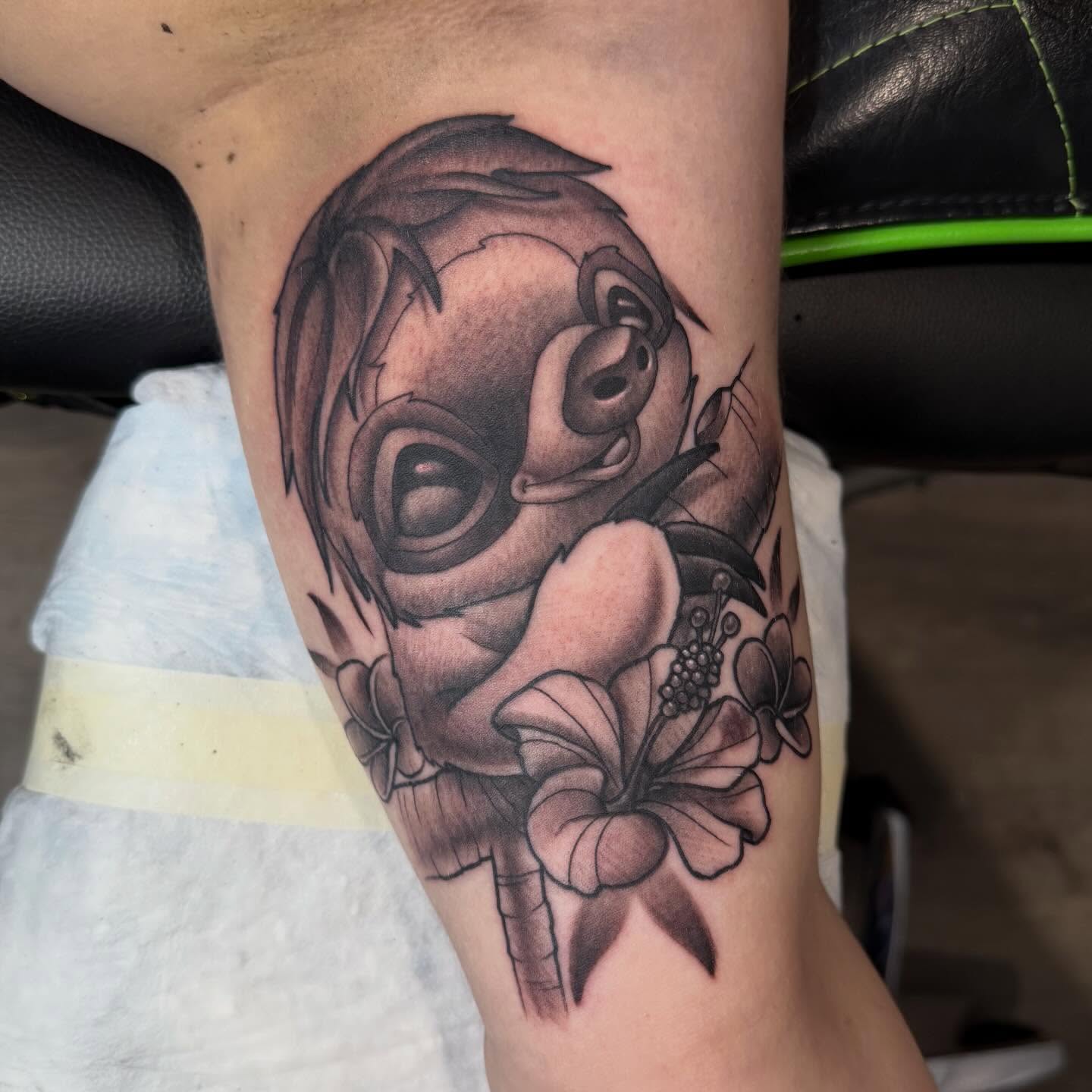 Monkey with flowers black and grey tattoo on the forearm by Matthew Gordon