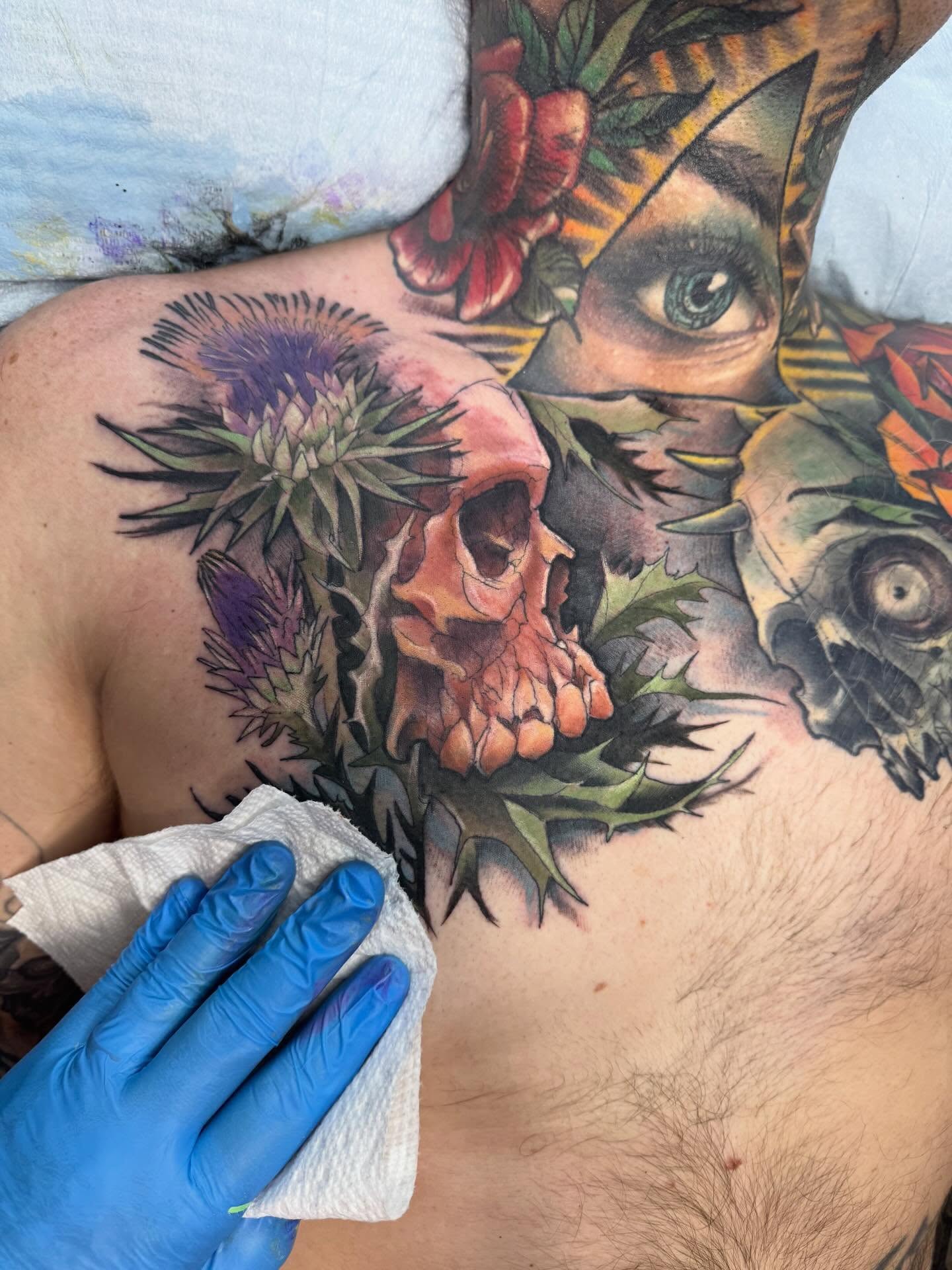 Skull and thistle American traditional tattoo on the chest by jonhighland