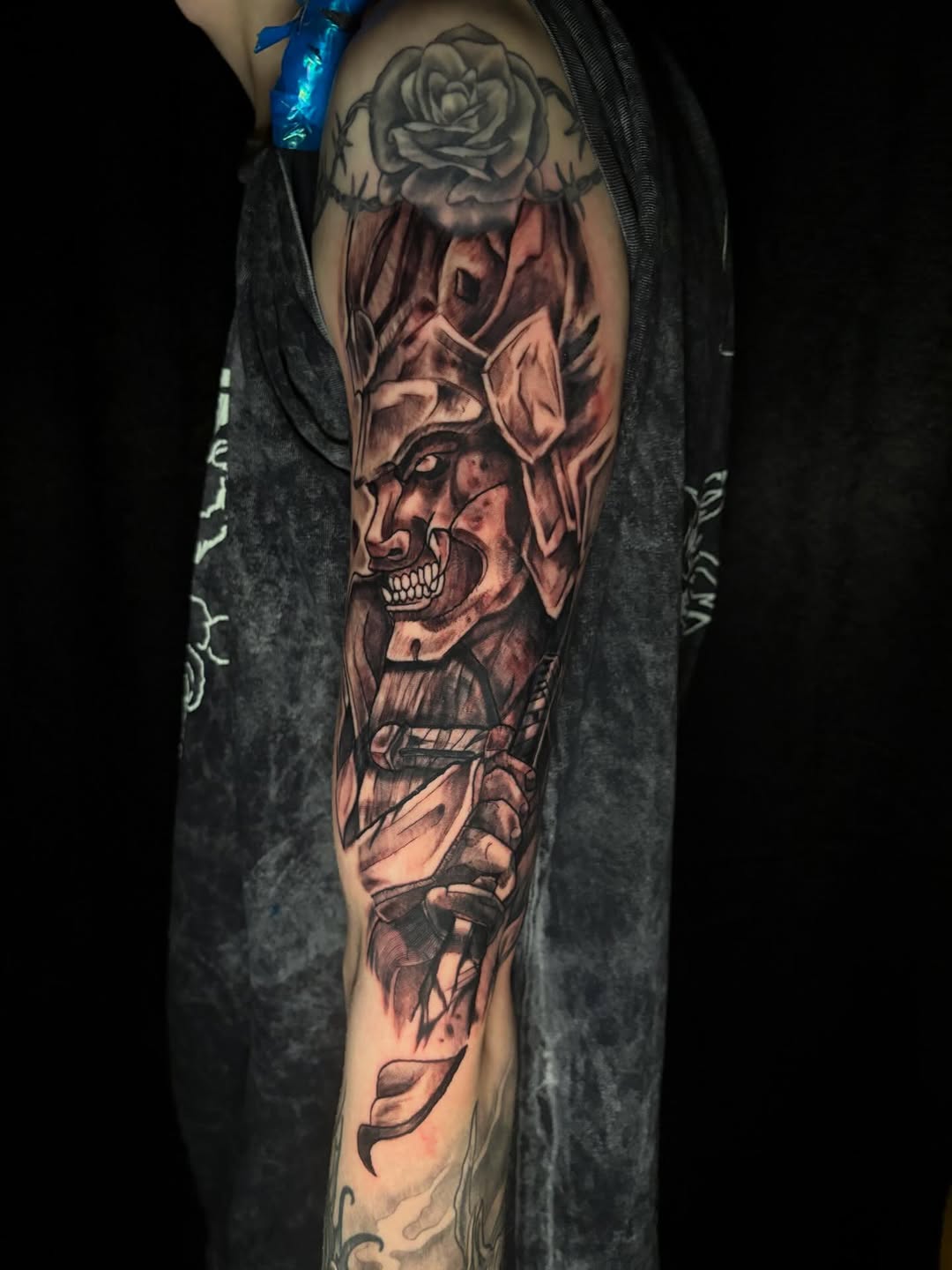 Samurai warrior with rose Japanese tattoo on the forearm by Skunk Punk