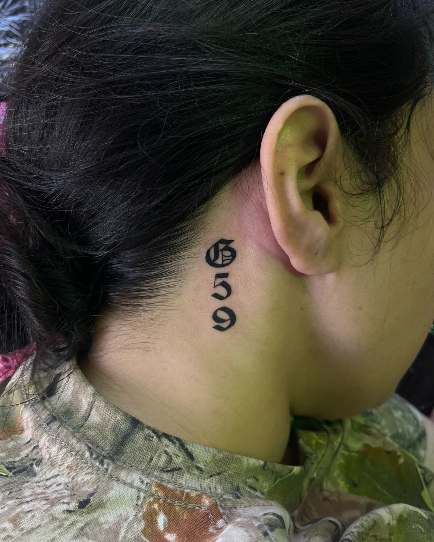 Numbers lettering script tattoo on the neck by Daniela