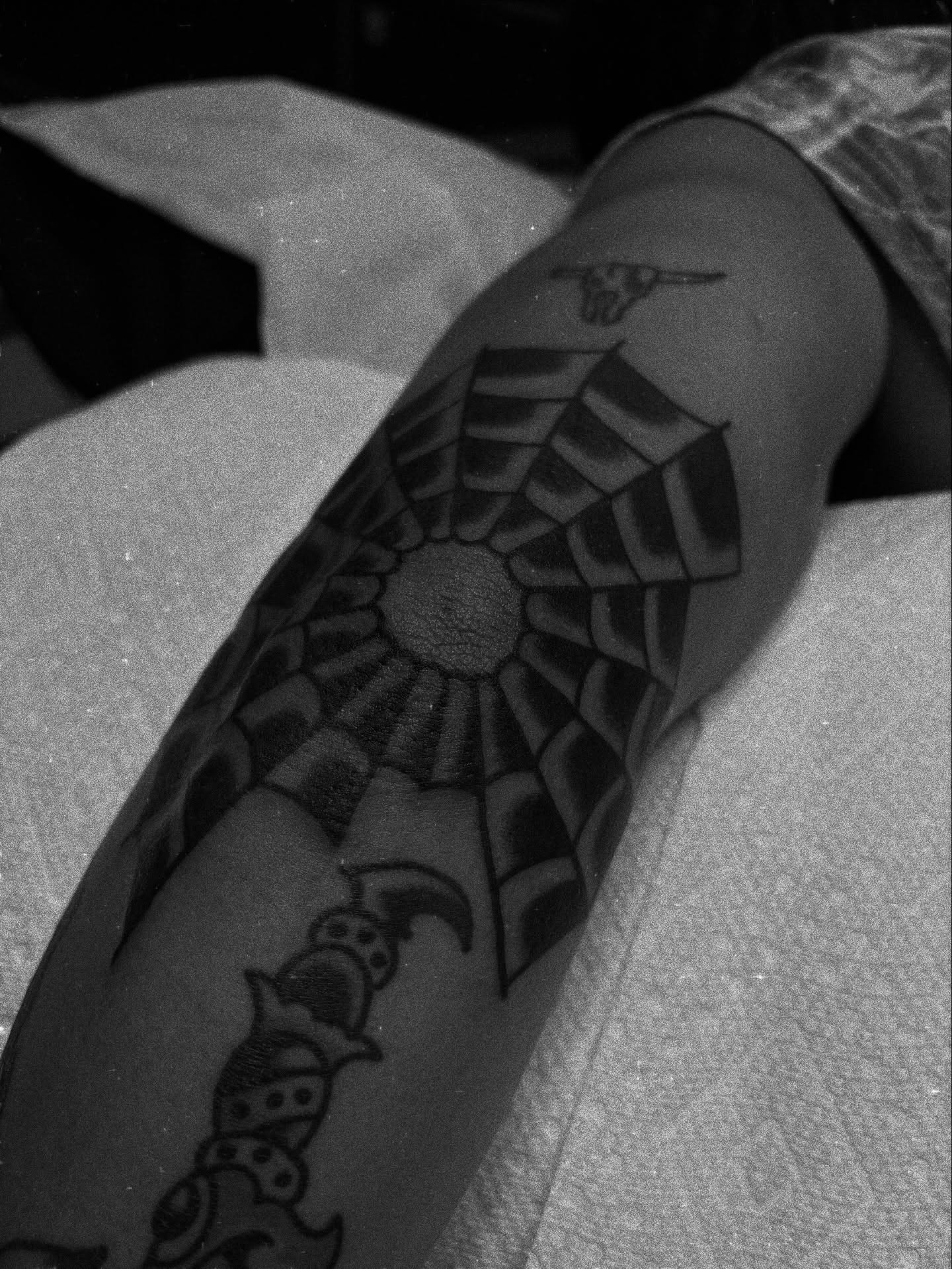 Geometric spiderweb geometric tattoo on the forearm by Carlos Gonzalez Tattoo, Dallas, Texas