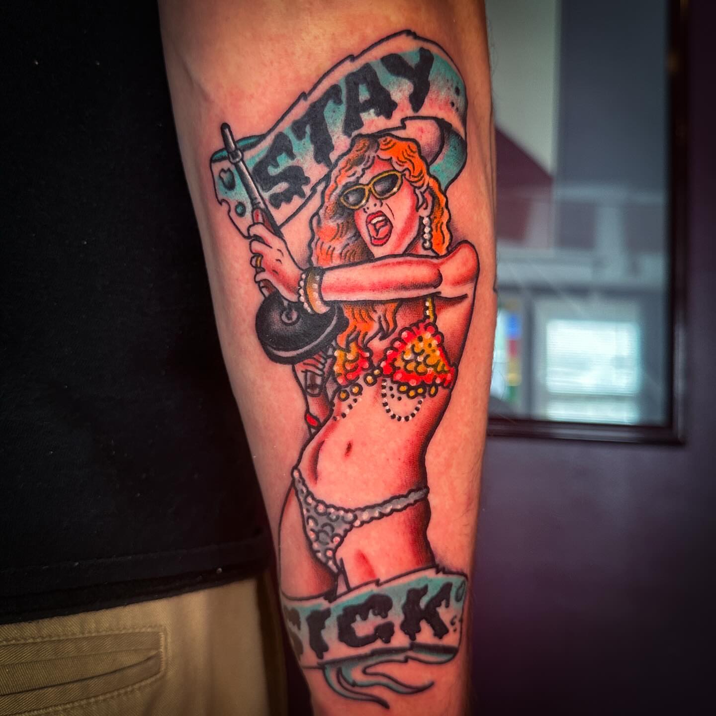 Woman with flag American traditional tattoo on the forearm by Stacey Colangelo