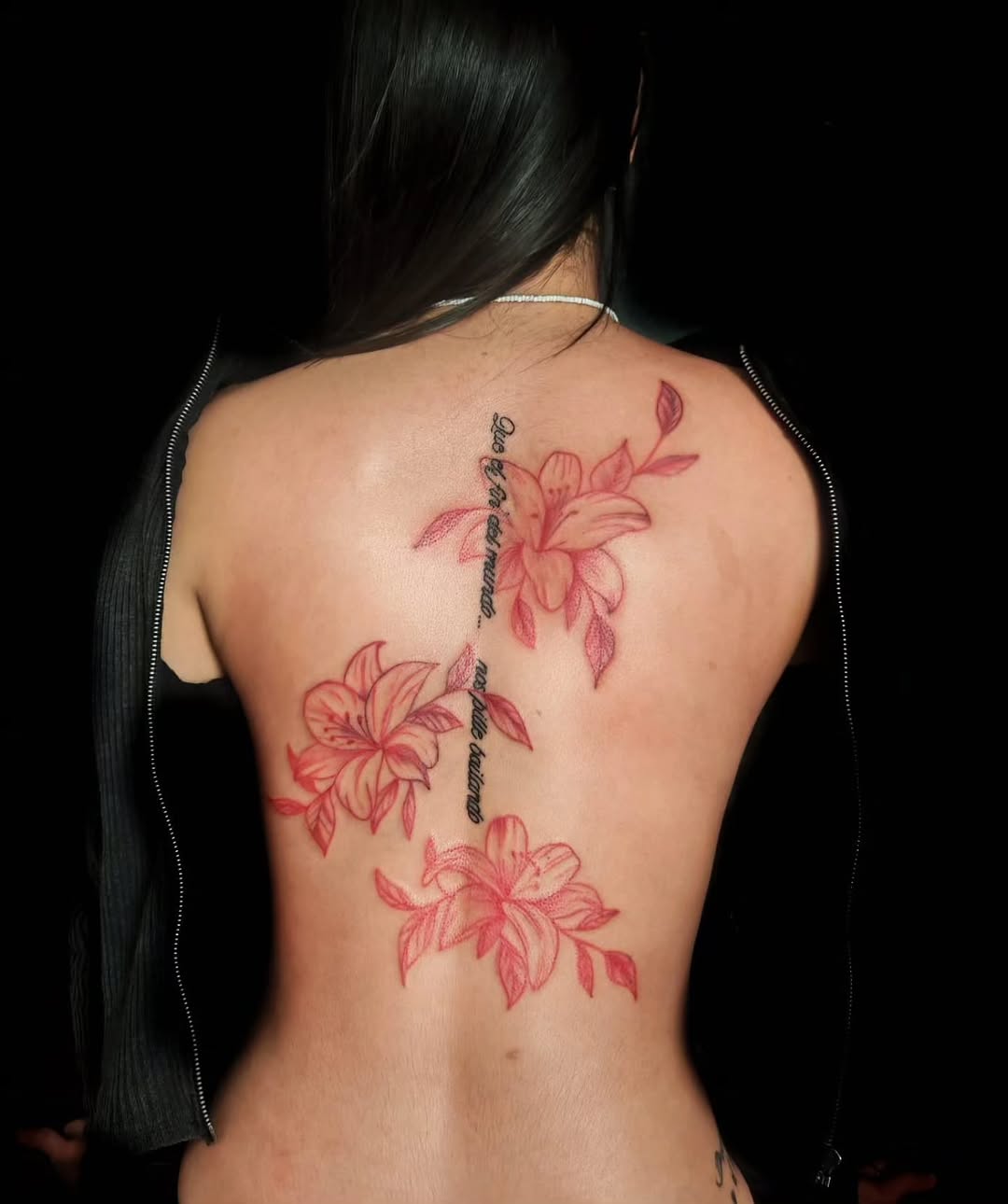 Lilies and script fine line tattoo on the back by Juanma Martin