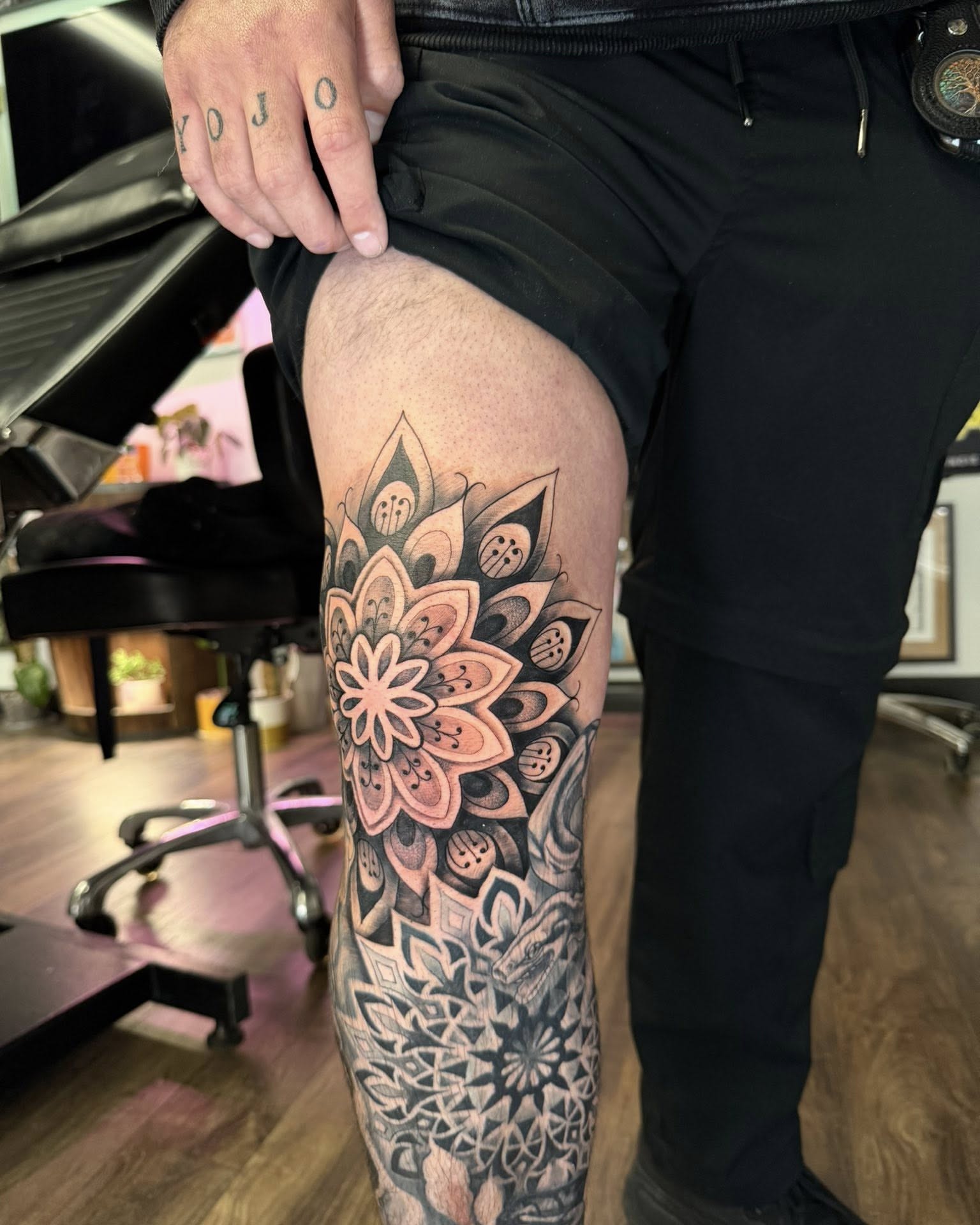Lotus flower dotwork tattoo on the thigh by Chad Meado