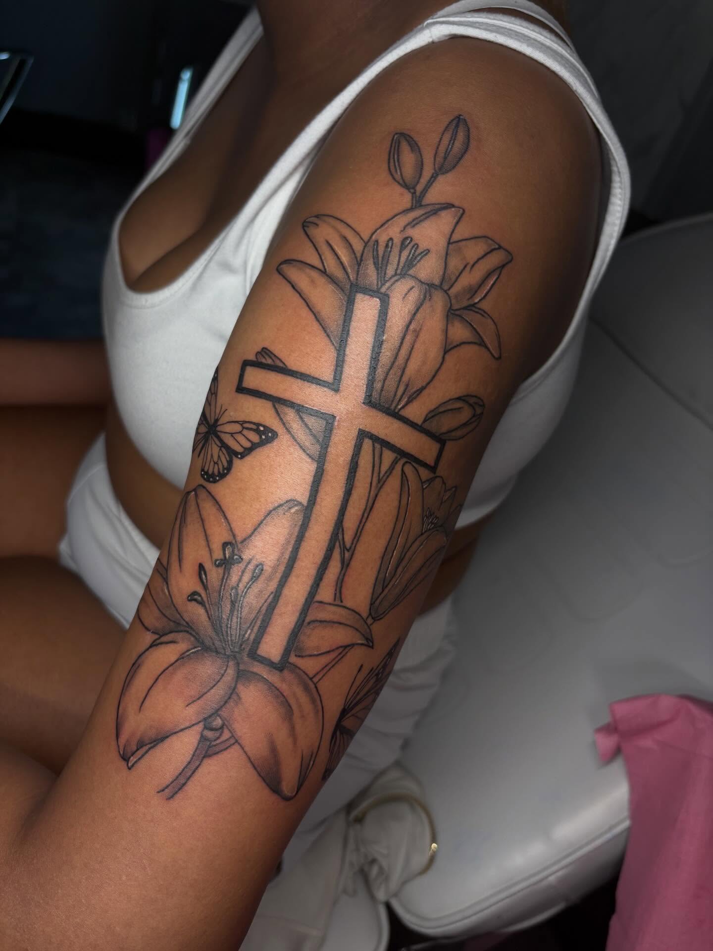 Cross with lilies black and grey tattoo on the forearm by addicted222inkk🎨