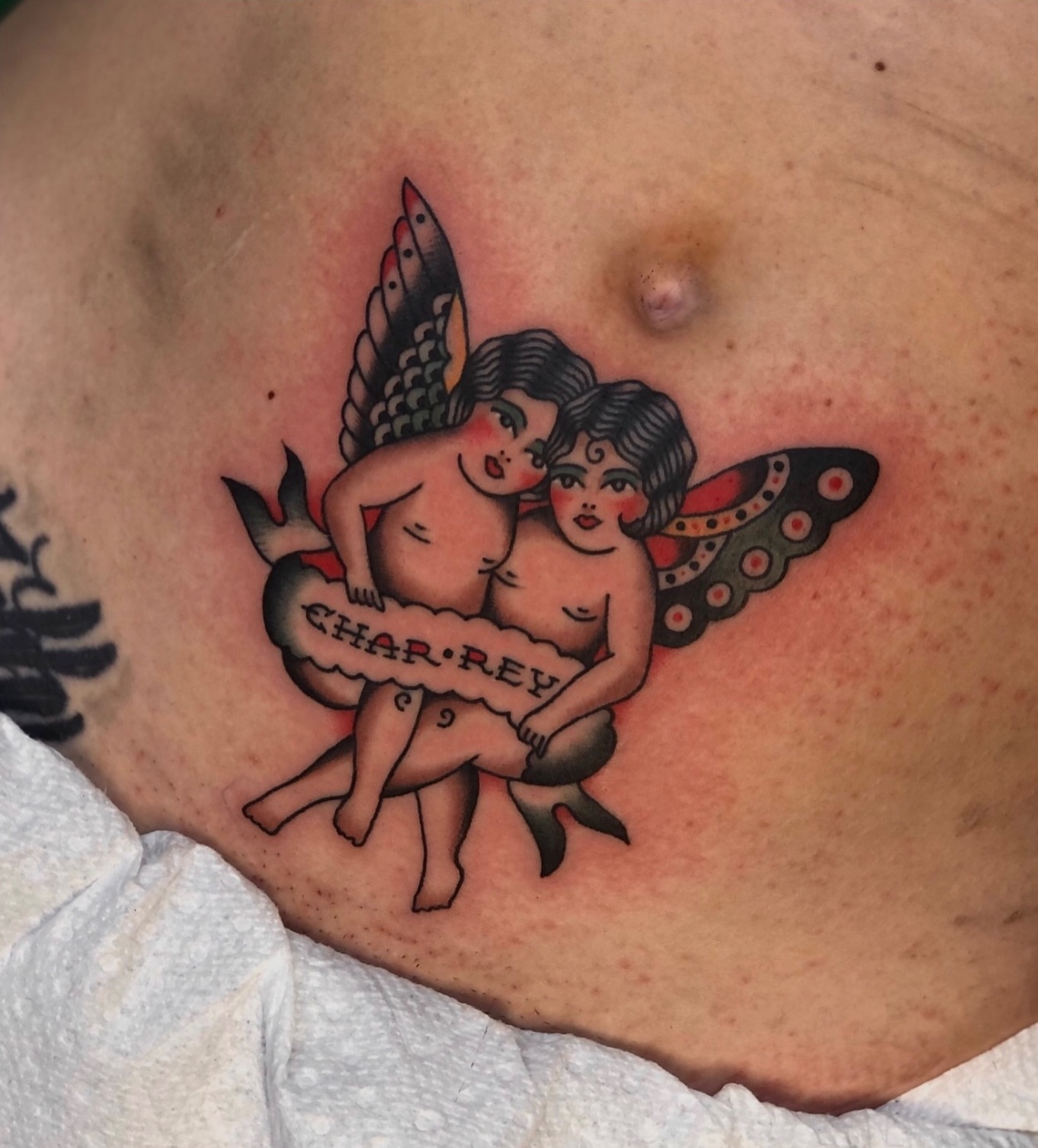 Cherubs American traditional tattoo on the chest by EVA Traditional Tattoos