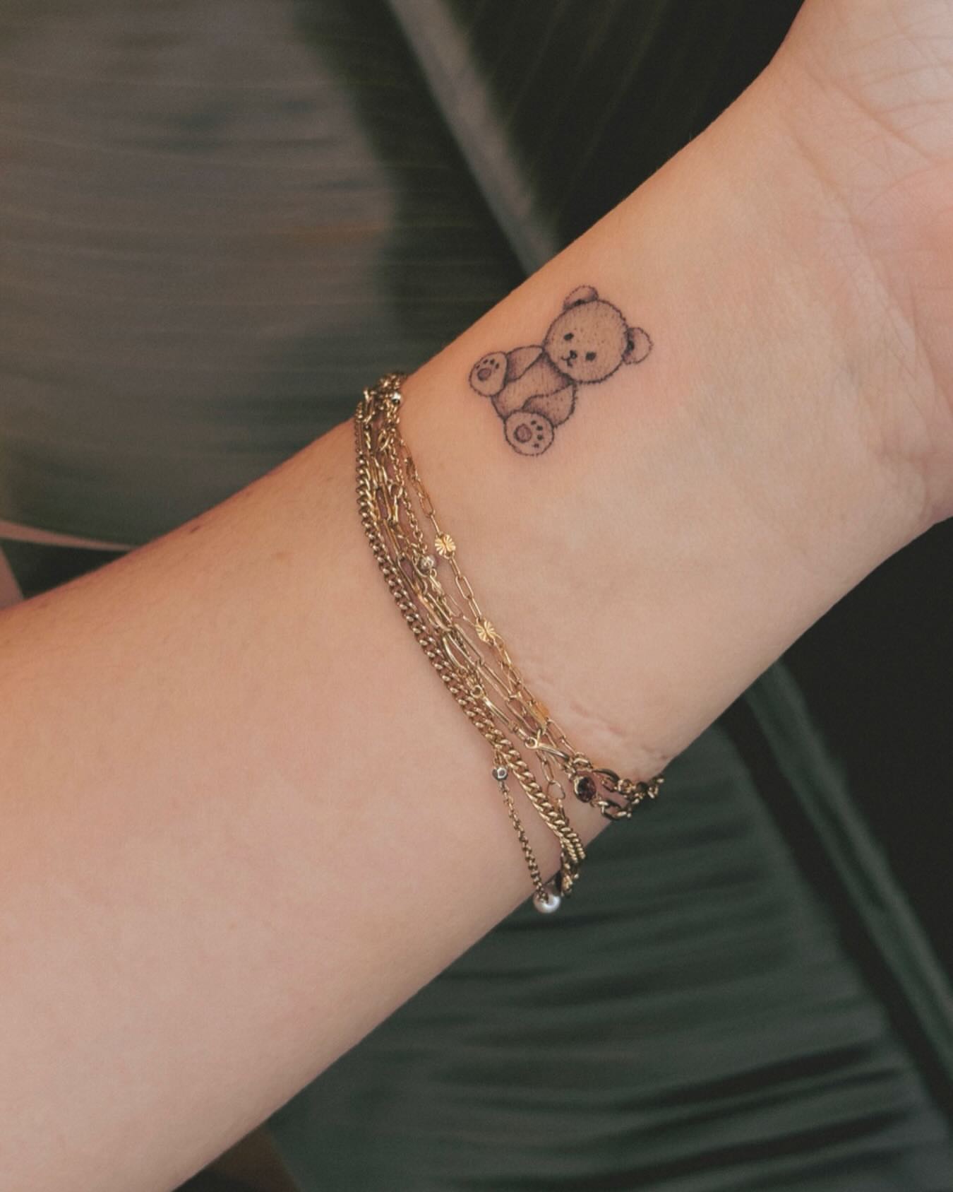 Teddy bear black and grey tattoo on the forearm by Ashley Pilgreen