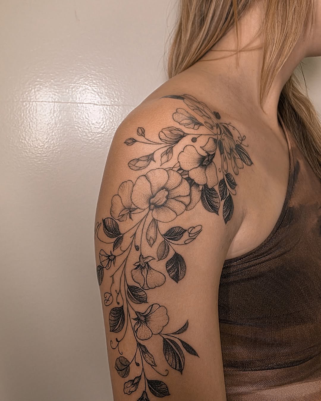Floral branch with bird dotwork tattoo on the shoulder by Richmond tattoo shop, Richmond, Texas