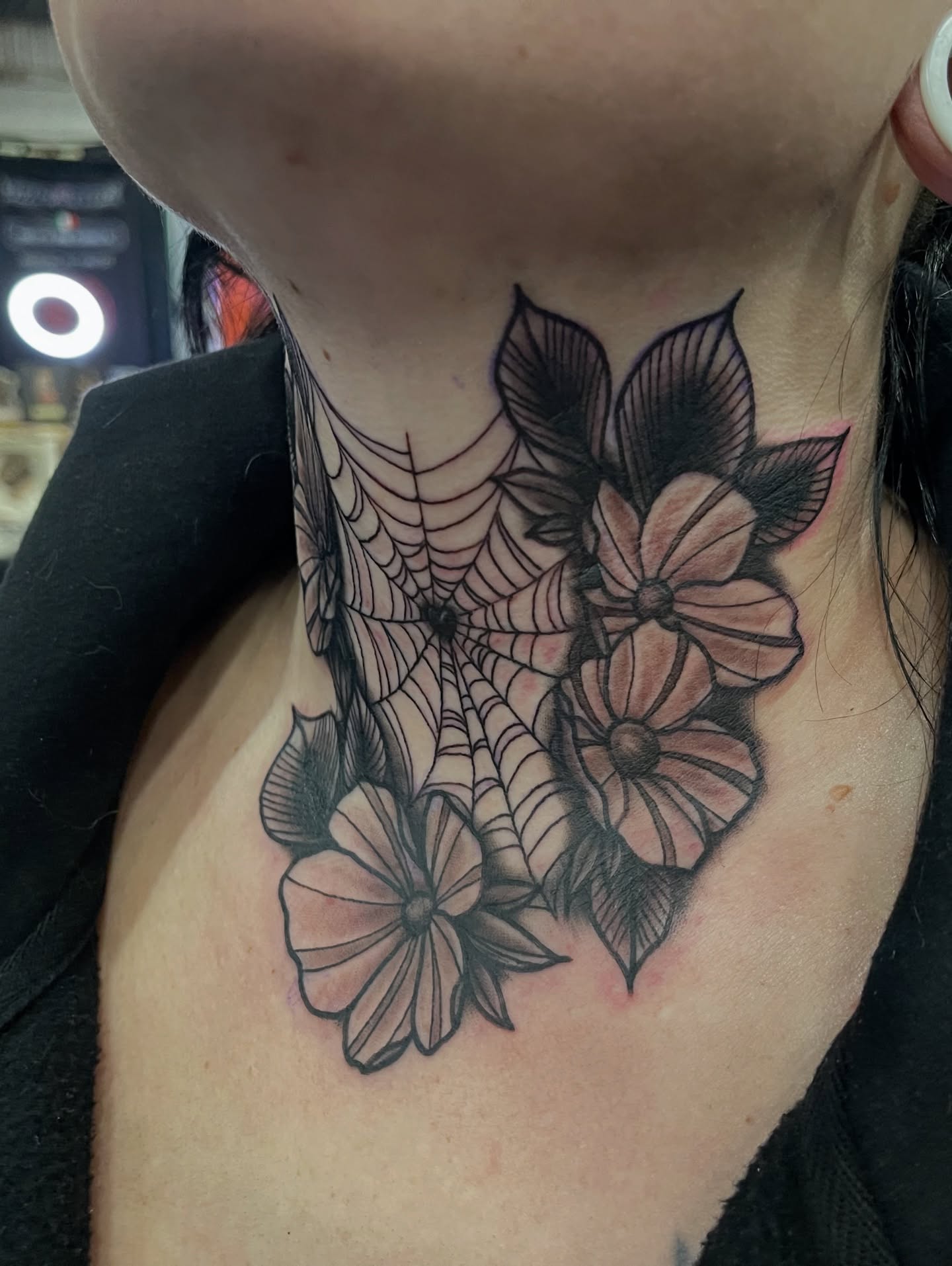 Spider web and flowers black and grey tattoo on the neck by Dale Callahan, Olympia, Washington